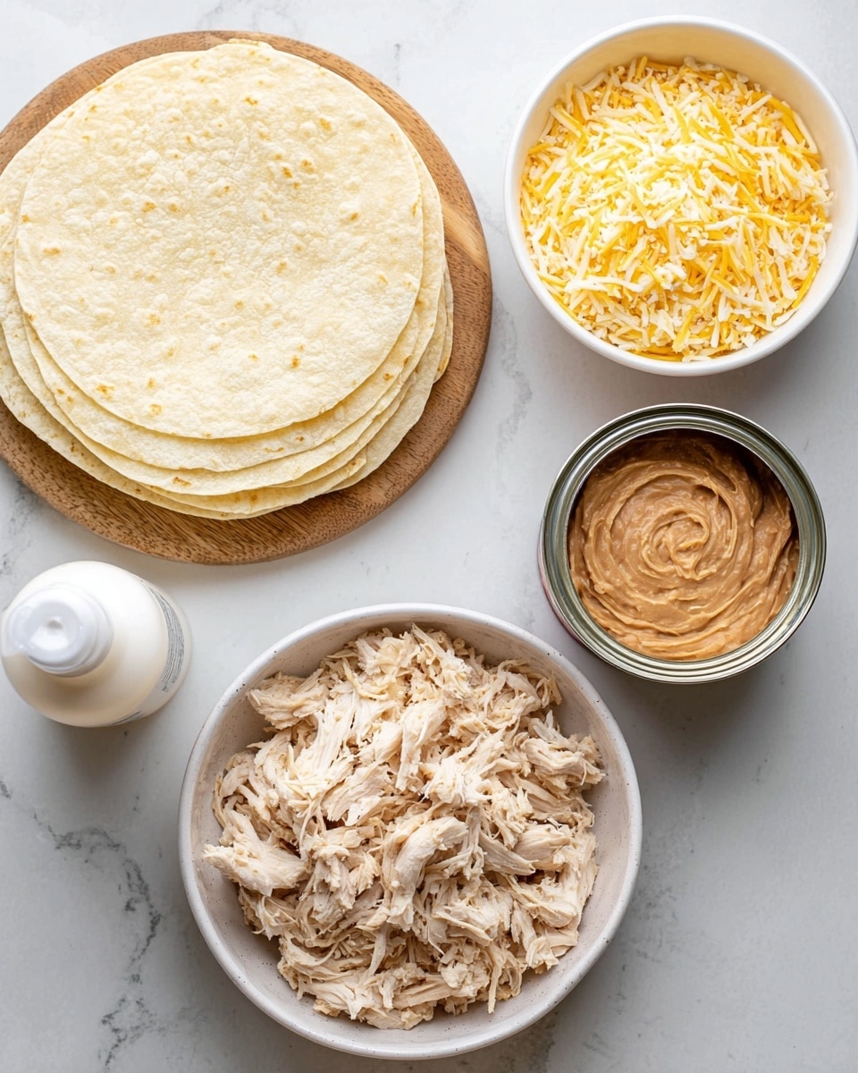 The image shows ingredients on a white marbled surface. On the top left, there is a stack of soft, pale yellow tortillas resting on a wooden board. To the top right, a white bowl is filled with shredded yellow and white cheese. Below the tortillas, there is an open can of refried beans with a swirled design on the surface. At the bottom center, a white bowl holds a large amount of shredded cooked chicken, light beige in color. On the bottom left, a white can of cooking spray is placed vertically. photo taken with an iphone --ar 4:5 --v 7