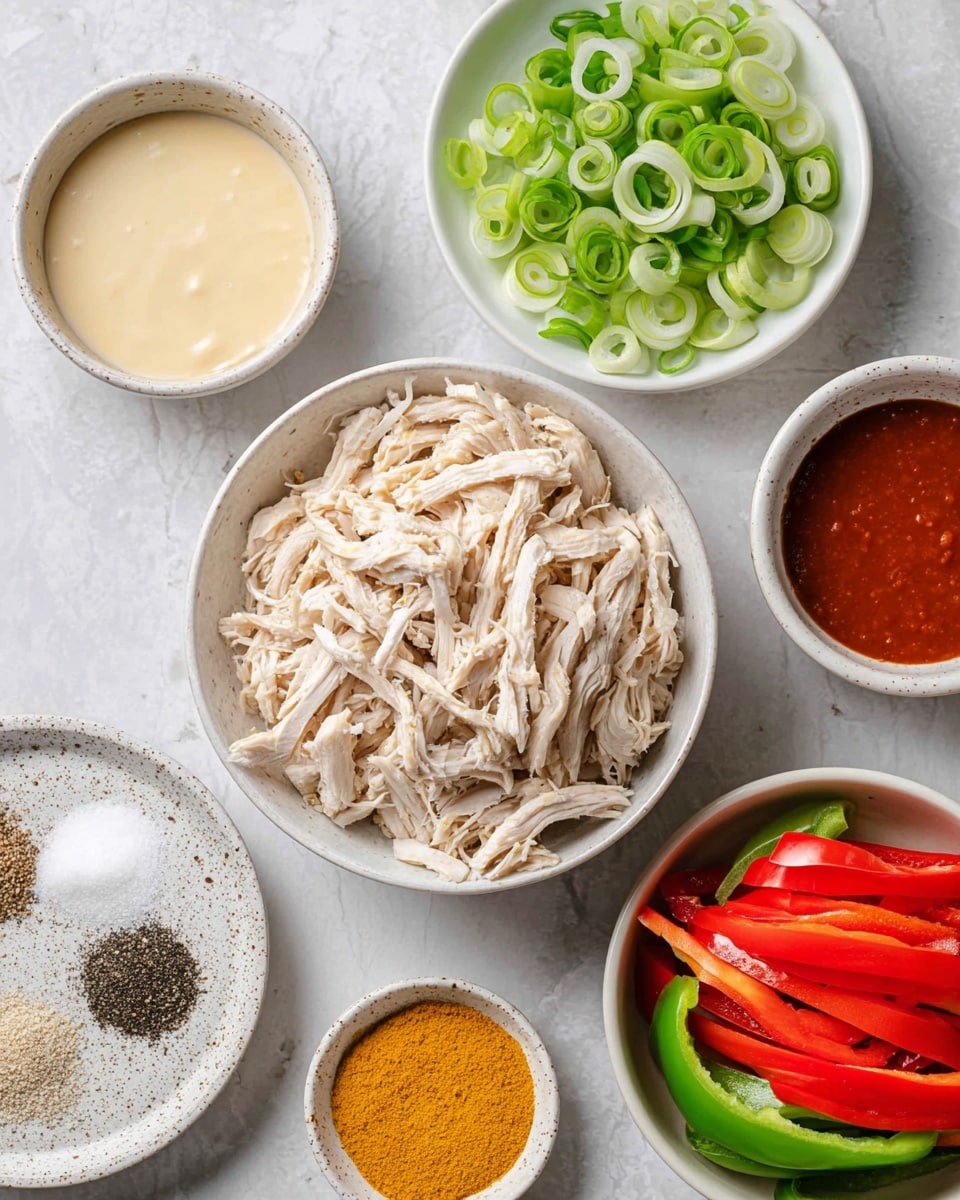 The image shows a top view of several white bowls and plates on a white marbled surface, each holding different ingredients. In the center, there is a white bowl filled with shredded cooked chicken, light beige in color. To the right, a white bowl contains halved red and green bell peppers, showing their smooth inner texture and seeds removed. Above those, a white plate holds thinly sliced green onions with vibrant green and white rings. Near the chicken bowl, a small white bowl contains a reddish-brown sauce with a smooth surface. To the left, another bowl holds a creamy pale yellow sauce, looking thick and smooth. At the bottom left, a white speckled plate is divided into four sections with black pepper, fine white powder, yellow powder, and light brown powder. Finally, a small bowl filled with bright yellow powder sits just below the chicken bowl. Photo taken with an iphone --ar 4:5 --v 7