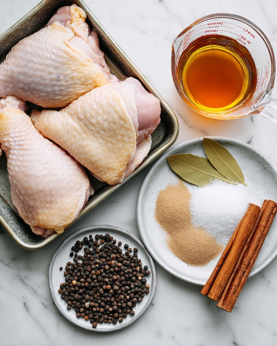 The image shows raw chicken thighs and drumsticks with pale pink and light yellow skin, neatly placed in a metal tray at the upper left. To the right, there is a clear glass measuring cup filled with an amber-colored liquid. Below it, a small white plate holds white salt and light brown sugar piled up next to each other. To the left of that plate, another white plate contains whole black peppercorns, cloves, bay leaves, and two long cinnamon sticks, creating a mix of dark brown, black, and green colors. All items are on a white marbled surface. Photo taken with an iphone --ar 4:5 --v 7
