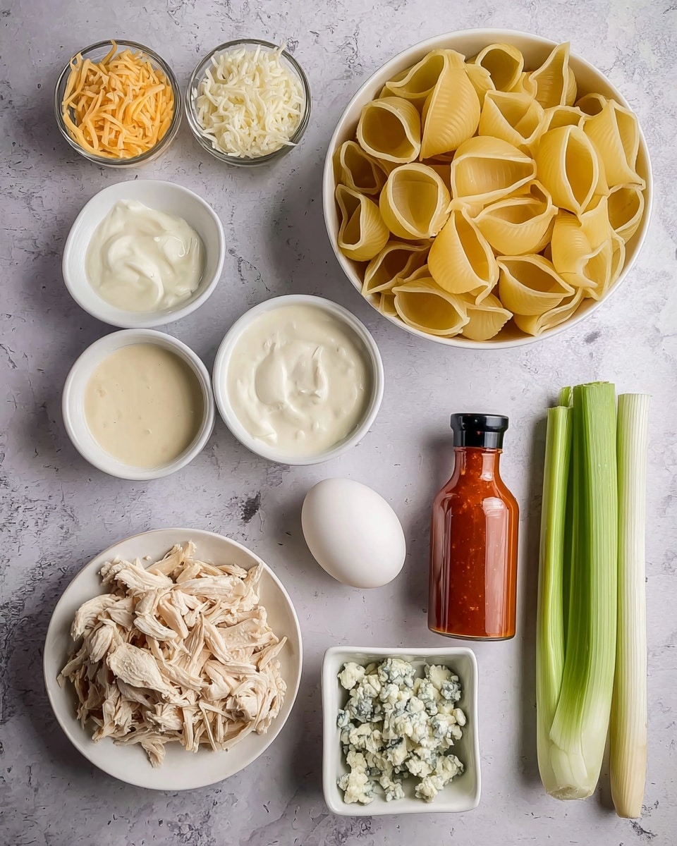 The image shows several ingredients placed neatly on a white marbled surface. There is a white bowl filled with long yellow pasta shells near the top right. To the left of it, there are three small white bowls stacked vertically: the top one has shredded cheese, the middle one is filled with soft white cheese, and the bottom one contains a creamy white sauce. Below the bowls, a white plate holds shredded cooked chicken. In the center, a white egg sits alone next to a small white square dish with crumbled blue cheese. On the right side, there are two whole green onions and a long stalk of celery next to a bottle of reddish hot sauce with a black cap. Photo taken with an iphone --ar 4:5 --v 7