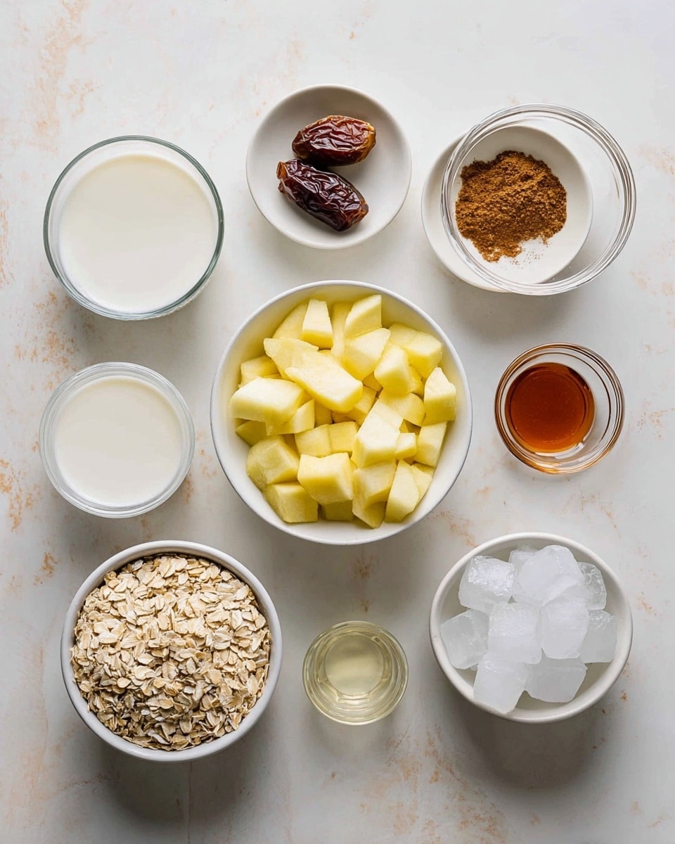 A top view of nine white bowls and small dishes arranged on a white marbled surface. In the center is a white bowl full of peeled and chopped yellow apples. Around it: a small white dish with a dark brown date, a small white dish with cinnamon powder, a small white dish with brown paste, a small white dish with amber syrup, a glass cup of white powder, a glass cup of white milk, a white bowl filled with beige rolled oats, and a white bowl filled with ice cubes. The items are evenly spaced and neatly arranged. Photo taken with an iphone --ar 4:5 --v 7