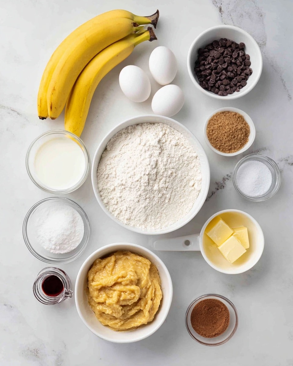 The image shows a top view of baking ingredients arranged on a white marbled surface. At the center, there is a white bowl filled with white flour. Below it, a smaller white bowl contains mashed bananas with a smooth, creamy texture. To the right of the flour, there is a white measuring cup filled with brown sugar and a white bowl with melted butter in a light golden-yellow color. Above these, a white bowl holds two whole white eggs, and nearby a white bowl contains dark chocolate chips in small round shapes. On the left side of the flour, a white measuring cup with plain yogurt, a small clear bowl with salt, and another small clear bowl with baking soda are placed. At the bottom left, a small white jar contains a dark liquid, likely vanilla extract, and a bunch of two bright yellow bananas lies on the upper left corner. The setup is clean and neatly organized with soft natural light. Photo taken with an iphone --ar 4:5 --v 7