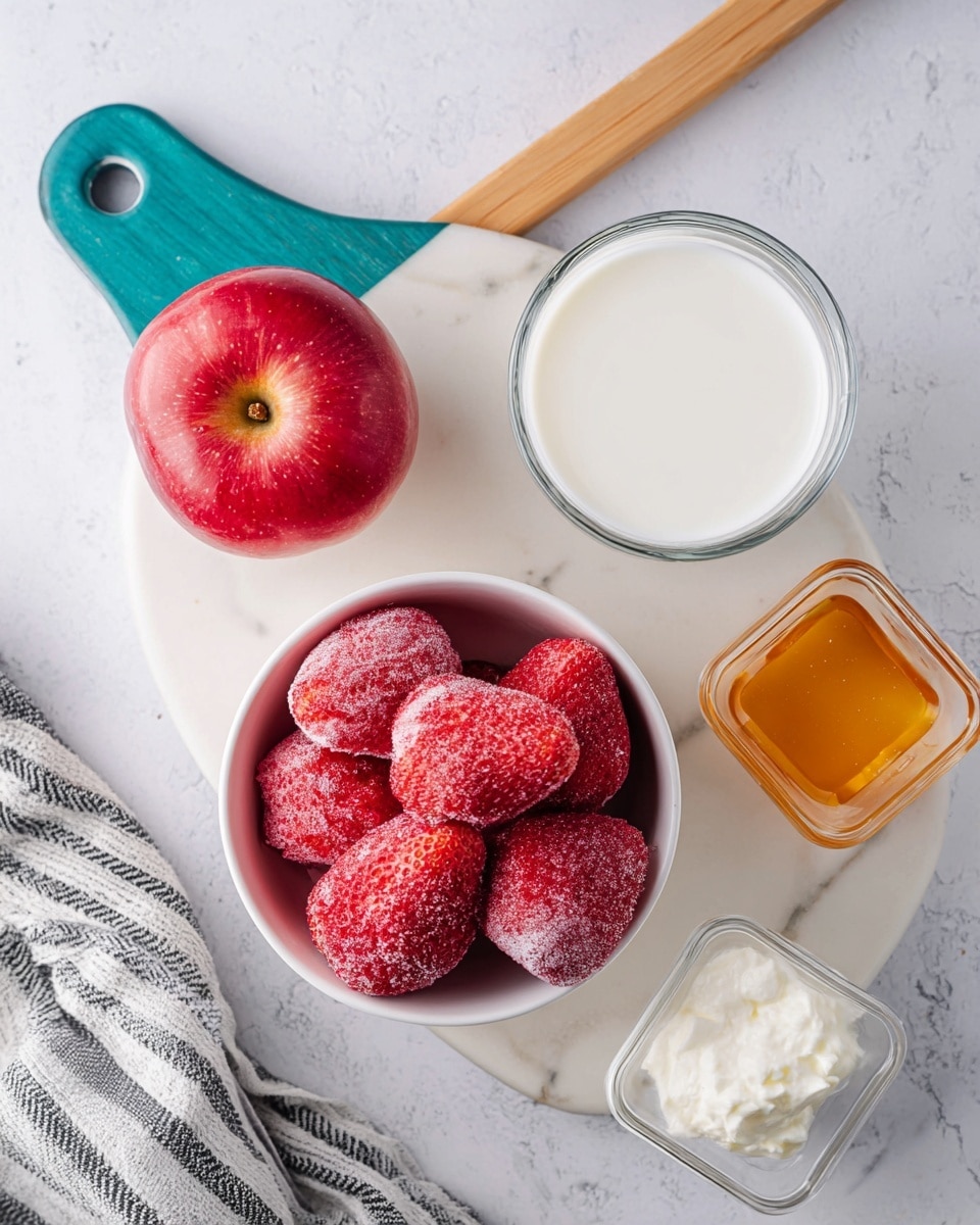The image shows a top view of a white small bowl filled with several large frozen strawberries that have a frosty texture. To the left of the bowl, there is a red apple with a glossy, shiny skin placed on a white marbled cutting board with a teal and wooden handle. Above the bowl, a clear glass contains white milk. To the lower right of the bowl, a small clear square container holds a fluffy, creamy white substance, likely yogurt. Below the bowl there is a small white cup with golden honey. The setup is on a white marbled surface with a gray and white striped cloth partially visible at the bottom left. photo taken with an iphone --ar 4:5 --v 7