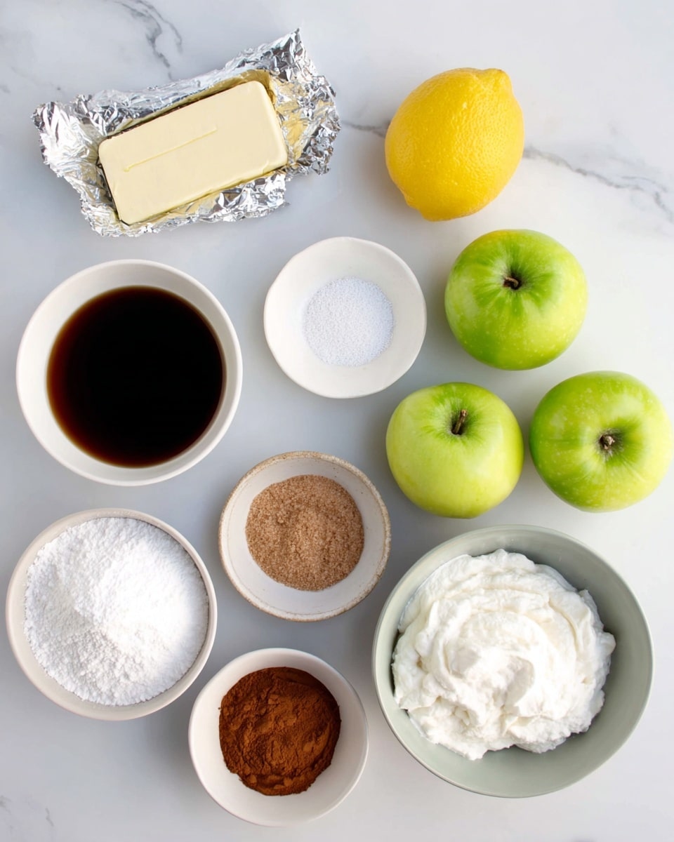A collection of baking ingredients arranged on a white marbled surface, including a white bowl with dark liquid (likely vanilla), a silver wrapped stick of butter, a yellow lemon, three green apples, a white bowl with brown sugar, a white bowl with cornstarch, a small white bowl with water, a grey bowl filled with powdered sugar, a white bowl with whipped cream, and a small white bowl with cinnamon powder. The ingredients are spaced evenly and lit with soft natural light, creating a clean and organized look photo taken with an iphone --ar 4:5 --v 7