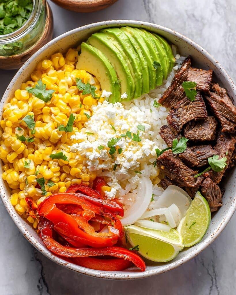 Southwest Steak Bowls with Grilled Corn, Peppers, Onions, and Cilantro Sauce Recipe
