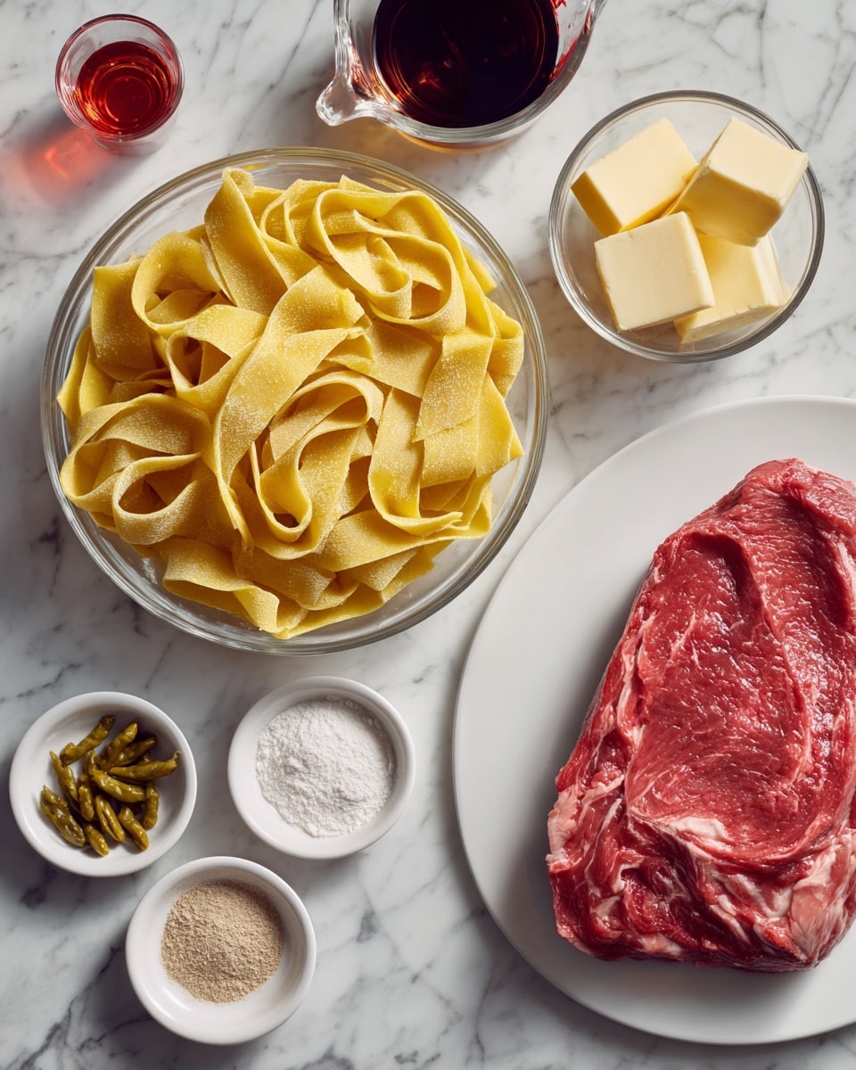 The image shows several cooking ingredients arranged on a white marbled surface. In the center, a glass bowl contains a pile of wide, flat yellow pasta strips with a slightly rough texture. Below this bowl, a white plate holds a large, raw piece of red meat with visible marbling of fat. To the right of the meat, a clear measuring cup is filled with a dark brown liquid. Above the liquid, a small glass bowl contains two pale yellow cubes of butter. To the left of the meat, there are three small white bowls: one with greenish-yellow pepperoncini peppers, one with a white powdery mix, and one with a light brown powder. In the upper left corner, a small clear cup holds a red liquid. photo taken with an iphone --ar 4:5 --v 7
