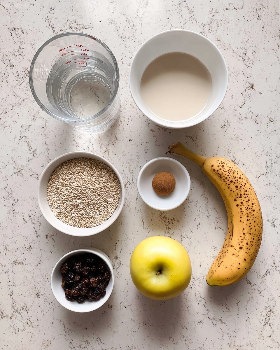 A top-down view of several ingredients arranged on a white marbled surface, including a clear glass measuring cup filled with water on the left, a white bowl with a light cream liquid near the top center, a smaller white bowl of white quinoa seeds to its right, a ripe yellow banana with brown spots to the right of the quinoa, a medium-sized yellow apple below the quinoa, a small white bowl filled with dark dried berries near the bottom center, a small white dish holding a light brown yeast ball below the water, and a tiny brown container of ground cinnamon placed between the water and the quinoa. photo taken with an iphone --ar 4:5 --v 7
