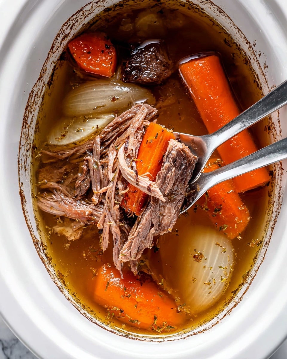 The image shows a close-up view of a white slow cooker filled with a rich broth containing large chunks of orange carrots, pale translucent onion slices, and dark brown cooked beef pieces. A silver two-pronged fork lifts shredded strands of the beef from the broth, showing the tender, fibrous texture of the meat. The broth is clear with floating herbs and spices, giving a warm golden-brown color. The slow cooker rim and inside surface are visible, with slight cooking residue. All of this is set against a white marbled background. photo taken with an iphone --ar 4:5 --v 7
