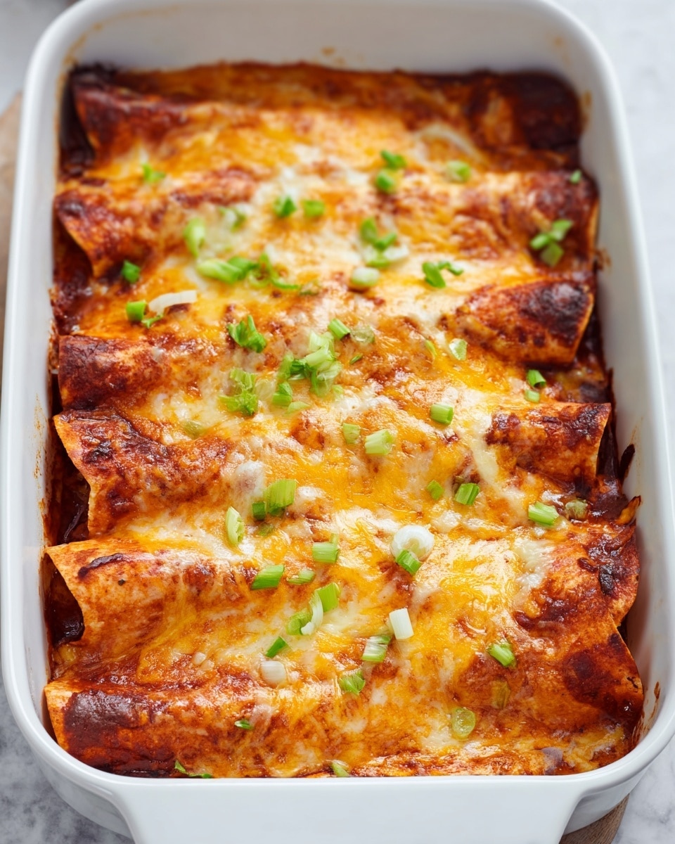 The dish shows a white baking dish filled with five rolled tortillas layered side by side, each covered with a generous layer of melted golden-brown cheese that has patches of darker toasted spots, giving a slightly crispy texture on top. Under the cheese, the tortillas show a reddish-orange sauce that peeks through, suggesting a rich, saucy filling beneath. The dish is garnished with small pieces of green scallions scattered evenly across the top. The background is a soft, white marbled surface. photo taken with an iphone --ar 4:5 --v 7