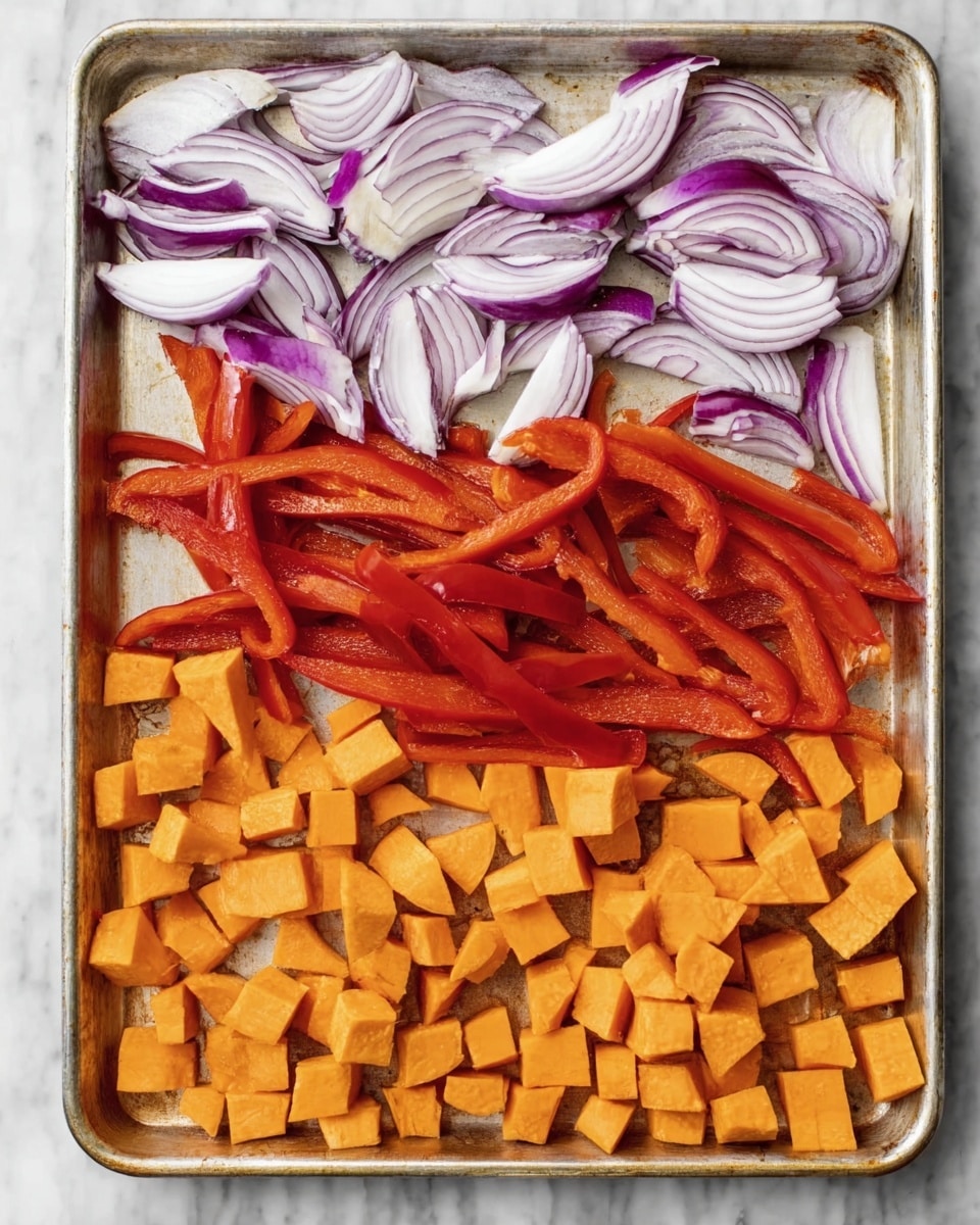 The image shows a white marbled surface with a silver baking tray on top that holds three kinds of sliced vegetables arranged in neat horizontal layers. At the top layer, there are thinly sliced purple and white onions with slight curves. The middle layer has long strips of red bell peppers with a shiny texture. The bottom layer contains bright orange cubes of sweet potatoes. The vegetables look fresh and ready for roasting, and the lighting highlights their vibrant colors and textures. Photo taken with an iphone --ar 4:5 --v 7