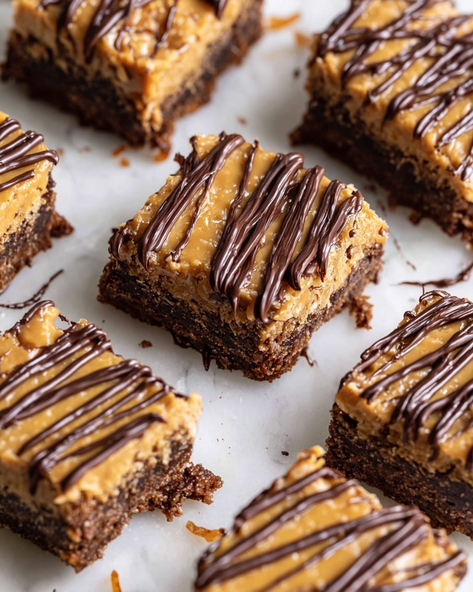 The image shows several square-shaped dessert bars arranged in a close group on a white marbled surface. Each bar has two main layers: a dense, rich dark brown base and a thick golden caramel-like topping that looks creamy and textured with coconut shreds. On top, thin lines of dark chocolate drizzle decoratively cross each bar diagonally. The bars have slightly uneven edges, with some small crumbs and smudges on the surface around them. photo taken with an iphone --ar 4:5 --v 7