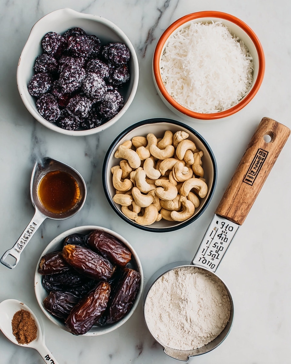 The image shows six containers arranged closely on a white marbled surface. In the top left, there is a white bowl filled with dark purple frozen berries covered lightly with frost. To the right of it, a white ceramic bowl with orange edges holds fine, white shredded coconut. Below the coconut, a white bowl with a black rim is filled with light brown cashew nuts that have a smooth texture. Below the cashews, a white ceramic measuring cup with orange edges marked