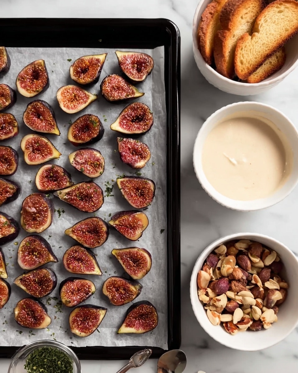 A black baking sheet lined with parchment paper holds two rows of halved, roasted figs, each with a caramelized, dark purple skin and a warm, soft red-orange interior showing seeds with a slightly textured surface; the figs are arranged neatly on the left side. Surrounding the baking sheet on the white marbled surface are four white bowls: the top right bowl filled with smooth, creamy off-white sauce; the middle right bowl containing several toasted golden-brown round slices of bread with a crispy texture; the bottom middle bowl with finely chopped mixed nuts with brown and cream colors; and the bottom left bowl with a small amount of dried green herbs. The scene has soft, natural lighting. photo taken with an iphone --ar 4:5 --v 7
