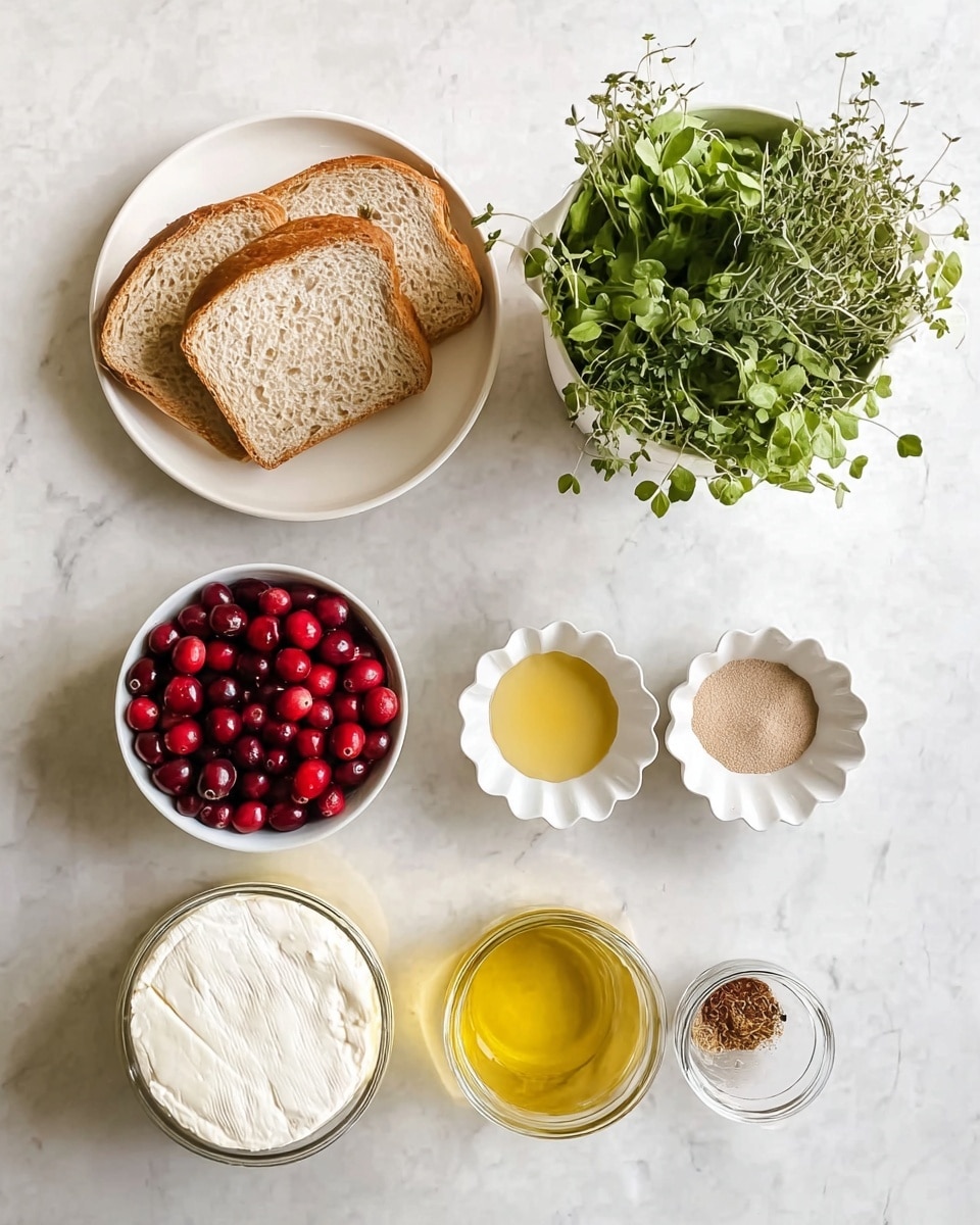 The image shows a white marbled surface with seven main items arranged neatly. In the top left, there is a white plate with four slices of light brown bread. Next to it on the right is a pot filled with fresh green herbs. Below the herbs, two small white bowls with scalloped edges hold a light brown powder and a golden liquid. Below the bread is a white bowl full of bright red cranberries. At the bottom left is an open container of creamy white cheese, and near the center bottom is a small glass jar filled with yellow oil. Lastly, at the bottom right corner, a very small white bowl contains a small brown spice. Photo taken with an iphone --ar 4:5 --v 7