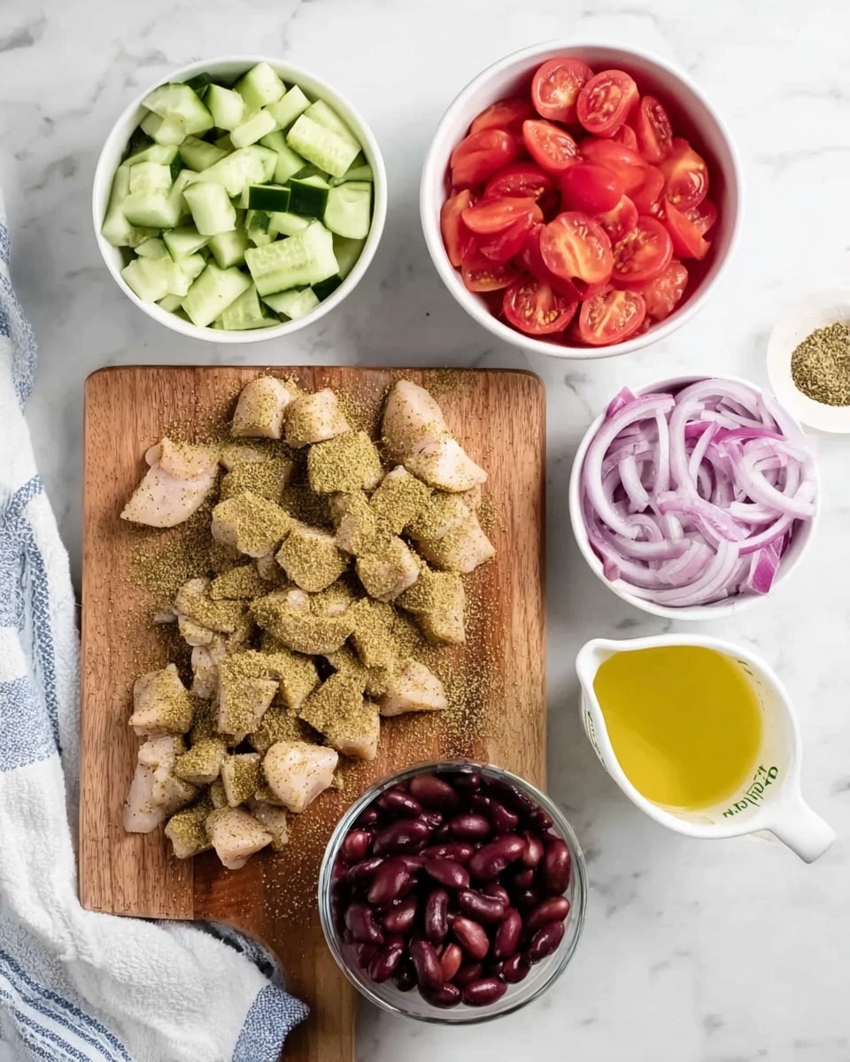 The image shows a wooden cutting board placed on a white marbled surface, with small pieces of light pink chicken spread across it, covered in a greenish-brown spice mix. Above the cutting board are four white bowls arranged in a loose square: the top left bowl contains roughly chopped light green cucumber, the top right bowl holds halved bright red cherry tomatoes, the bottom left bowl is filled with dark red kidney beans, and the bottom right bowl has thinly sliced rings of purple onion. To the far right of the bowls is a white measuring cup filled with a yellow liquid. A white cloth with blue stripes is partially visible on the bottom left corner. photo taken with an iphone --ar 4:5 --v 7