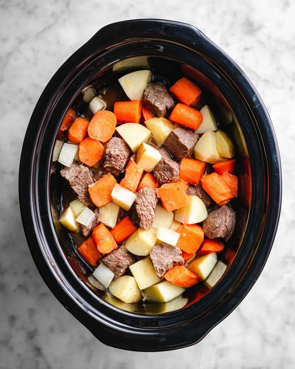 The image shows a top view of a black slow cooker filled with chunks of raw beef, sliced orange carrots, yellow potatoes, and white onions mixed together. The beef pieces are brownish with a raw texture, scattered evenly among thick slices of carrots, cubed potatoes, and chopped onions. The slow cooker is placed on a white marbled surface with a smooth texture. Photo taken with an iphone --ar 4:5 --v 7