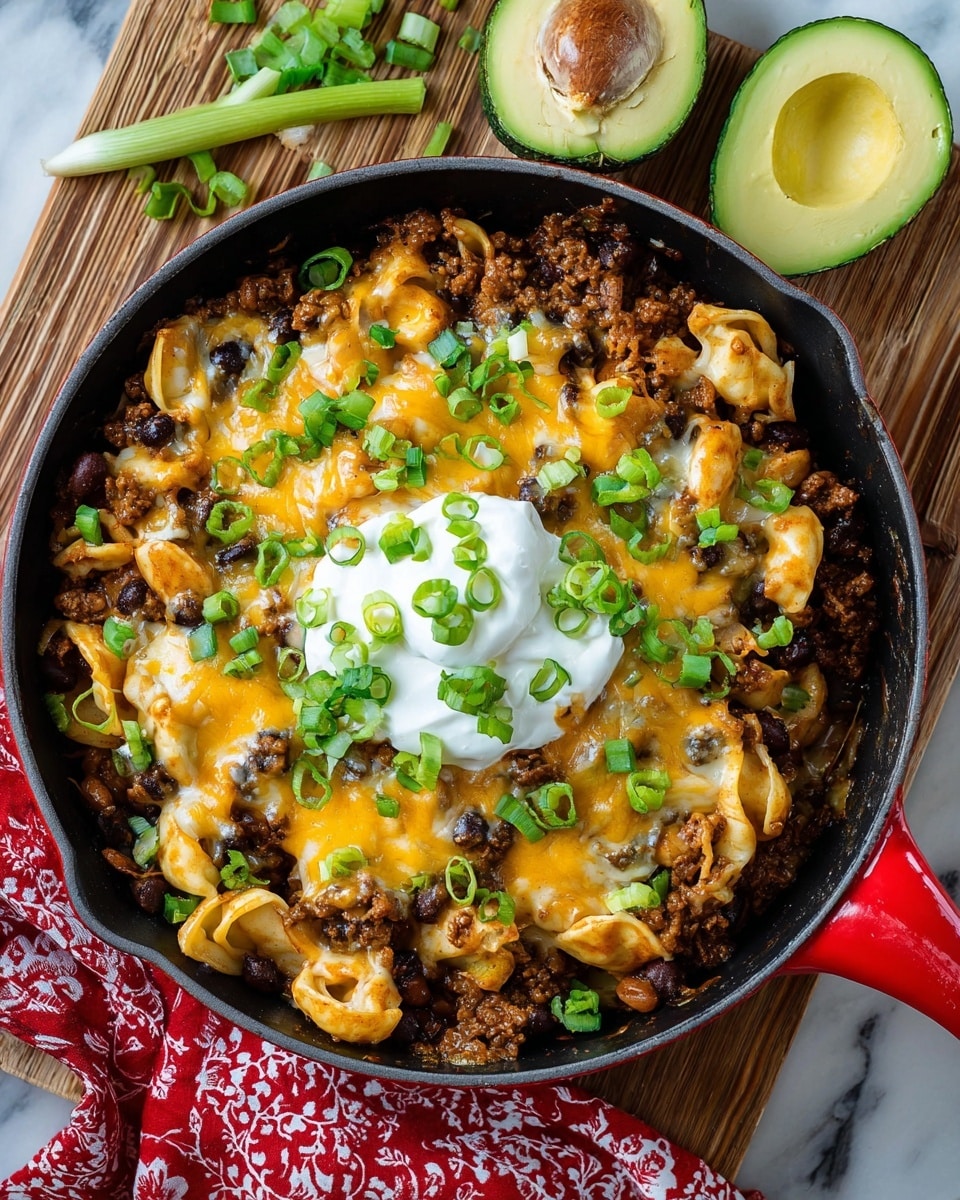 A black cast iron pan on a white marbled surface shows a layered pasta dish in four stages: the first layer has cooked tortellini pasta mixed with ground meat, black beans, and small red tomato pieces. The second layer is a thick coat of shredded yellow and white cheese covering the pasta mix. The third layer shows melted cheese blending with the pasta and meat, forming a creamy, bubbly top with some browned spots. The final layer adds a dollop of white sour cream in the center, scattered chopped green onions, and sprinkles of fresh green herbs over the melted cheese for garnish. Photo taken with an iphone --ar 4:5 --v 7