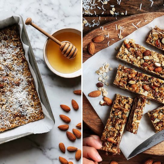 The image shows two views of homemade granola bars. On the left side, a square metal baking pan with white parchment paper holds an uncut granola mixture with a rough texture, topped with shredded white coconut flakes and visible pieces of almonds and oats. Nearby on a white marbled surface are a small white bowl filled with honey with a wooden honey dipper resting on it. On the right, the granola mixture is cut into rectangular bars and arranged on white parchment paper over a wooden cutting board. The bars show layers of oats, nuts, and coconut with uneven textured tops sprinkled with shredded coconut. Almonds, oats, and shredded coconut are scattered around the board and surface. A woman's hand holds a knife with a wooden handle beside the bars, ready to cut more. The background is a white marbled texture --ar 4:5 --v 7