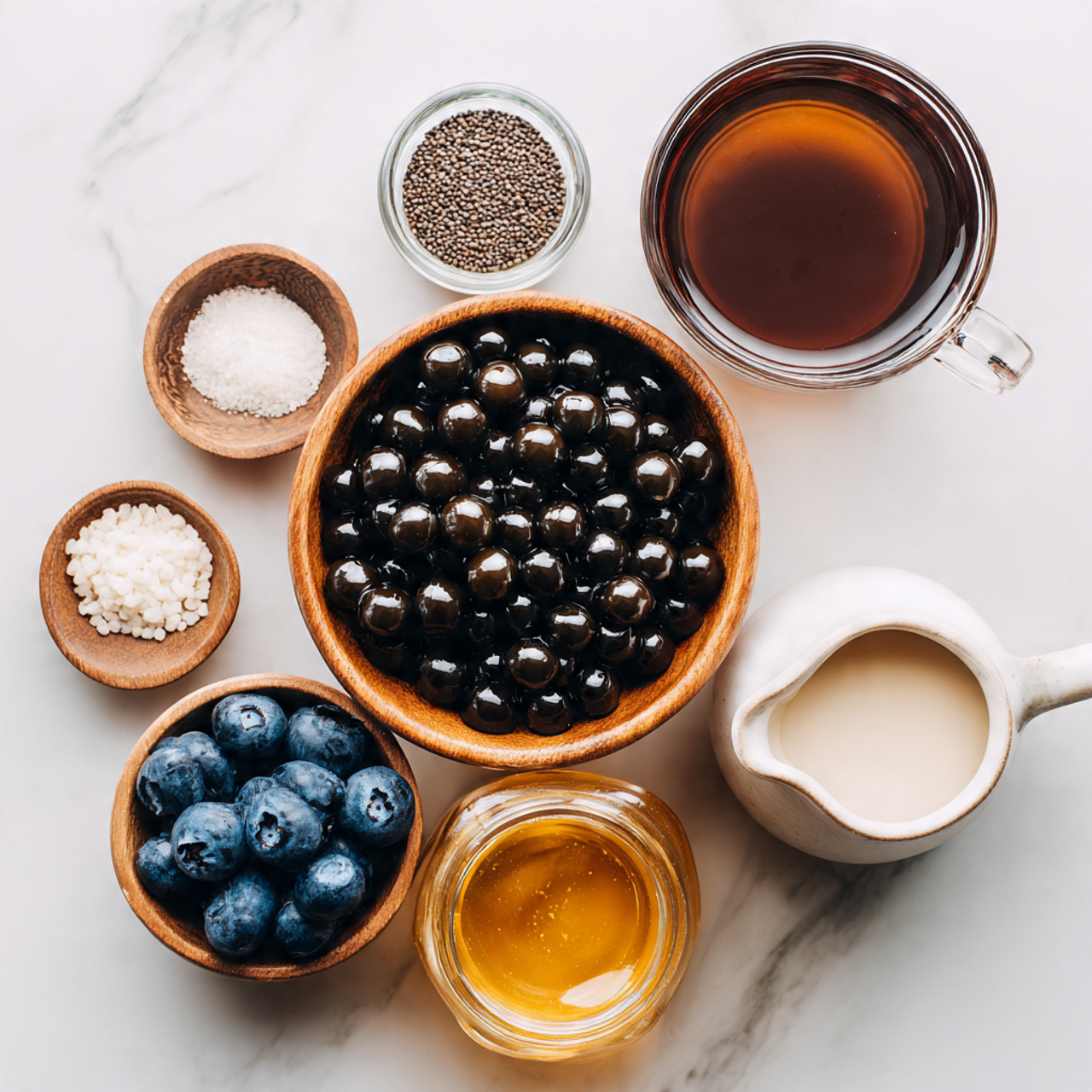 The image shows six small containers with different ingredients arranged on a white marbled surface. In the center is a wooden bowl filled with shiny black tapioca pearls. Above it to the right, there is a clear glass cup filled with dark brown tea. To the right of the cup, a white ceramic jug holds a light cream-colored liquid. Below the jug, a small clear jar contains fresh blueberries. Above and to the left of the tapioca pearls, a small wooden dish holds a white granulated substance, and next to that, a clear glass jar is filled with golden honey. The light is soft, and everything is placed neatly, showing the ingredients clearly and invitingly. photo taken with an iphone --ar 4:5 --v 7