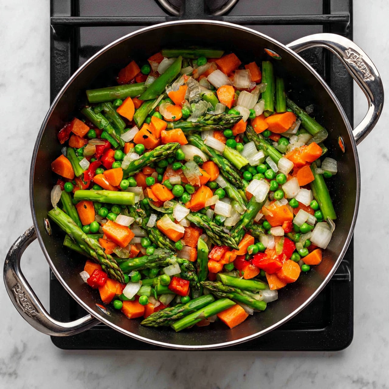 A black cooking pot filled with a colorful mix of chopped vegetables sits on a stovetop. The vegetables include bright green asparagus pieces, light green asparagus stalks, small round green peas, chopped white onions, and vibrant red bell pepper chunks. The vegetables are evenly spread throughout the pot, showing different textures like firm asparagus tips and soft onion pieces. The pot has shiny silver handles and is positioned on black burner grates. The scene is set on a white marbled textured surface. photo taken with an iphone --ar 4:5 --v 7