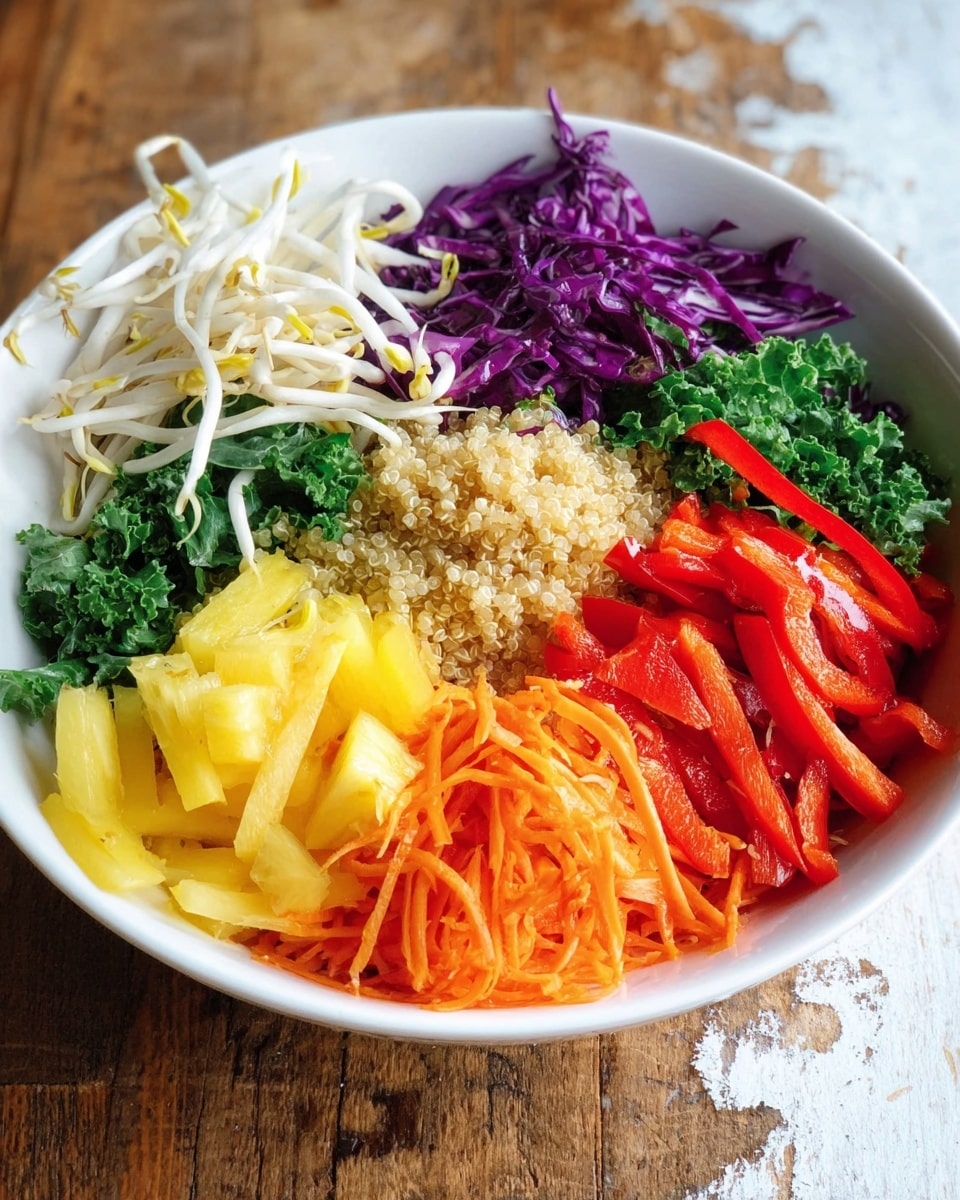 A white bowl full of colorful fresh vegetables and grains, arranged in neat sections. Starting from the left, there are long white bean sprouts with smooth texture, next to a small pile of light beige quinoa forming the base layer. Above the quinoa, there is a deep green leafy kale layer with a slightly rough texture. To the right of the kale are thin strips of purple cabbage with a glossy look. Beside the cabbage, there are bright red bell pepper slices that show a shiny and crisp texture. Below these, chunks of yellow pineapple with a juicy and slightly fibrous texture fill a section. At the bottom left, shredded orange carrots create a fine, soft layer. The bowl sits on a surface with a white marbled texture, with two red chili peppers placed nearby. The image looks sharp and bright, photo taken with an iphone --ar 4:5 --v 7