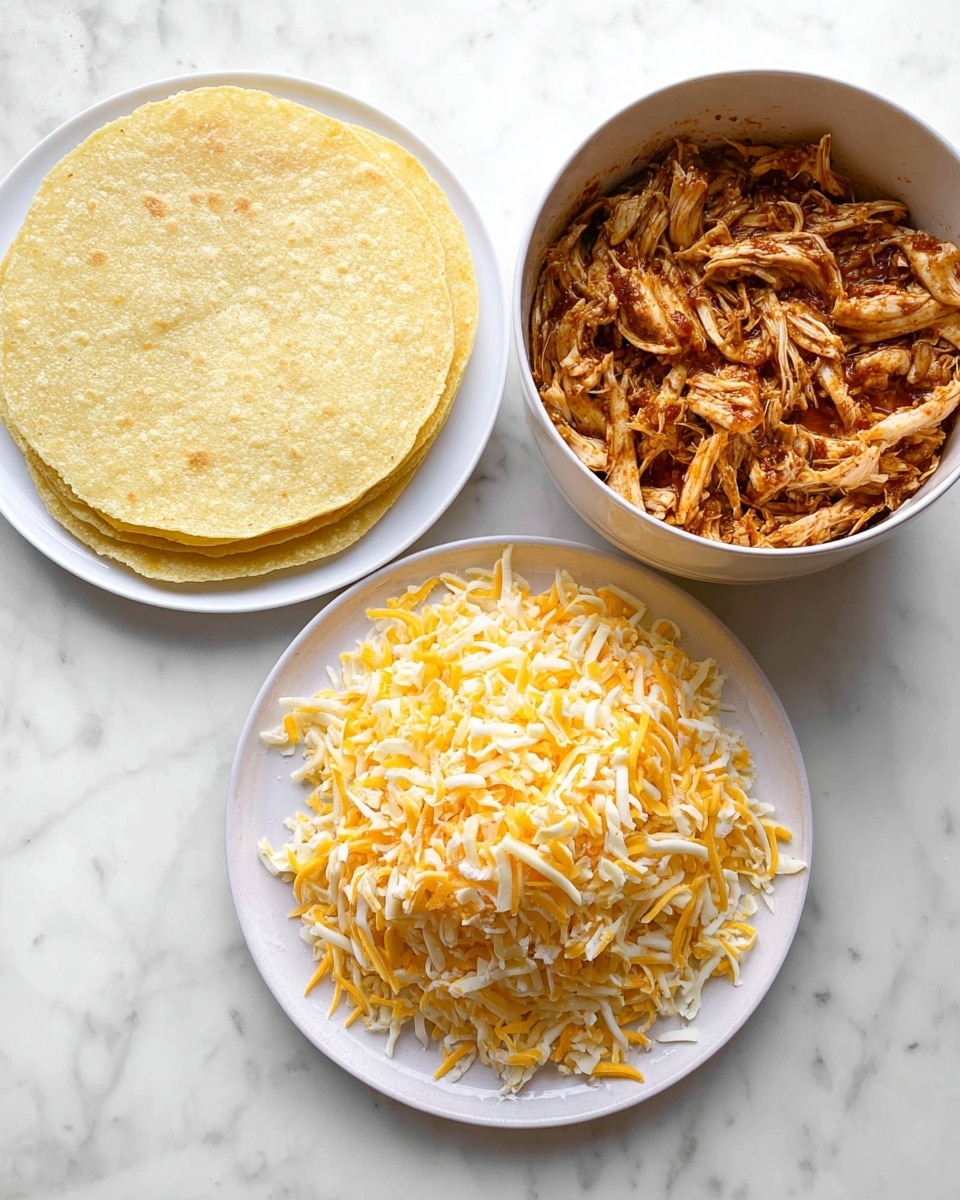 The image shows three items on a white marbled surface: on the left, a stack of plain, light yellow corn tortillas placed on a white plate, on the right, a white bowl full of shredded chicken mixed with a reddish-brown sauce, and in the foreground, a white plate heaped with shredded yellow and white cheese. Photo taken with an iphone --ar 4:5 --v 7