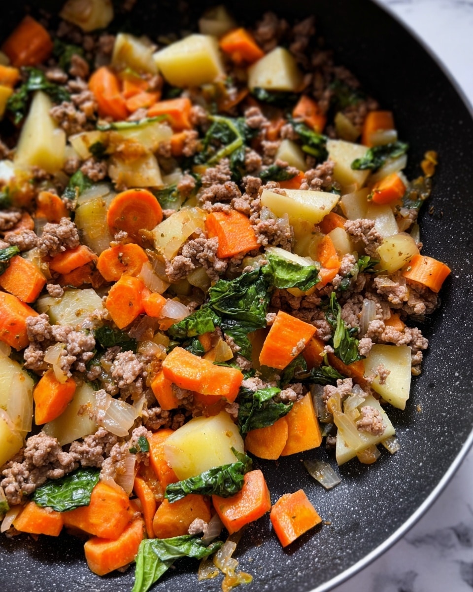 The image shows a close-up of a cooked dish in a dark pan, with three main layers mixed together: small chunks of orange carrots cut into thick sticks and slices, small pieces of light yellow potatoes, and ground meat that is light brown and crumbly. Scattered among these are some small pieces of green leafy vegetables with a soft texture. The dish looks warm and slightly oily with visible bits of translucent cooked onions throughout. The background is a white marbled texture. photo taken with an iphone --ar 4:5 --v 7
