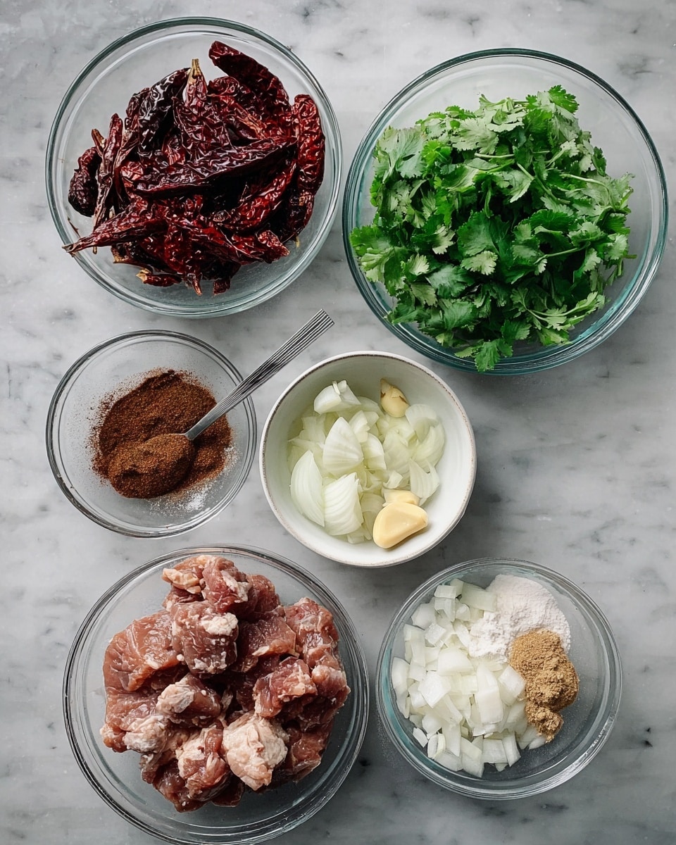There are six clear glass bowls arranged on a white marbled surface. The top bowl holds a handful of dry, dark red chili peppers. Below it to the left is a bowl filled with fresh bright green cilantro leaves. To the right of the cilantro bowl is a small white bowl containing chopped garlic and ginger, the garlic slices are light cream and the ginger pieces are pale yellow. Below the chili pepper bowl to the left is a bowl with dark brown spice powder and a silver spoon resting inside. To the right of this spice bowl is a larger bowl filled with raw meat chunks, dusted lightly with white flour. The bottom bowl contains roughly chopped white onion pieces. All the bowls are transparent except the small bowl with garlic and ginger which is white. Photo taken with an iphone --ar 4:5 --v 7