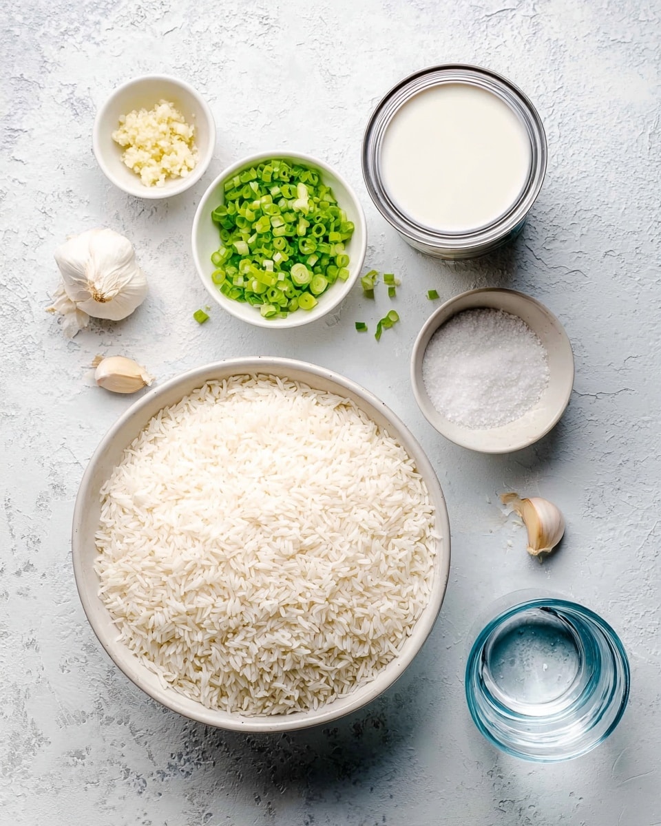 A top-down view of several ingredients arranged on a white marbled surface, featuring a large white bowl filled with uncooked white rice in the lower left, next to a small white bowl of chopped green onions above it, and another small white bowl of minced garlic beside the green onions. To the right, there is an open can of white coconut milk with a silver lid resting on the surface, a small white bowl with white salt, a clear glass measuring cup filled with water at the bottom right, and two garlic cloves near the bowls. The setup is clean, bright, and simple. photo taken with an iphone --ar 4:5 --v 7