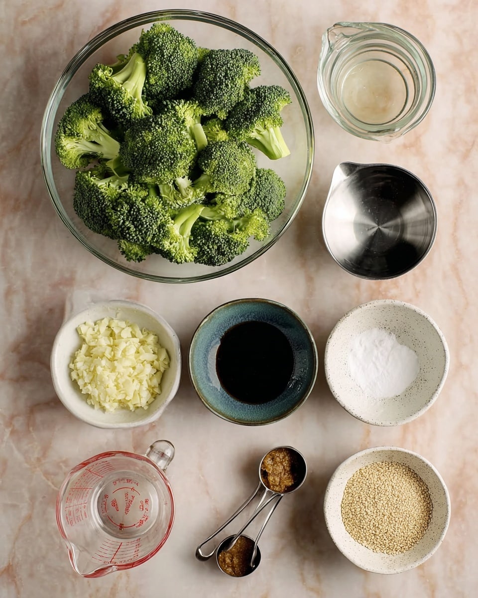 A top-down view shows a clear glass bowl at the top filled with fresh green broccoli florets, each piece textured with tiny, tight buds and light green stems. Below the bowl, eight small containers are arranged in two columns on a white marbled surface. The first column from left to right includes a white bowl filled with finely chopped pale yellow garlic, a bluish ceramic bowl with a dark brown paste, and a metal measuring cup containing a clear liquid. The second column features a speckled white bowl with a dark soy-like liquid, a small white bowl with white powder, and a clear glass container filled with tan sesame seeds. At the bottom center, a clear glass measuring cup with visible red markings is placed, next to two metal measuring spoons: one holding a small amount of dark liquid and the other filled with a light brown powder. photo taken with an iphone --ar 4:5 --v 7