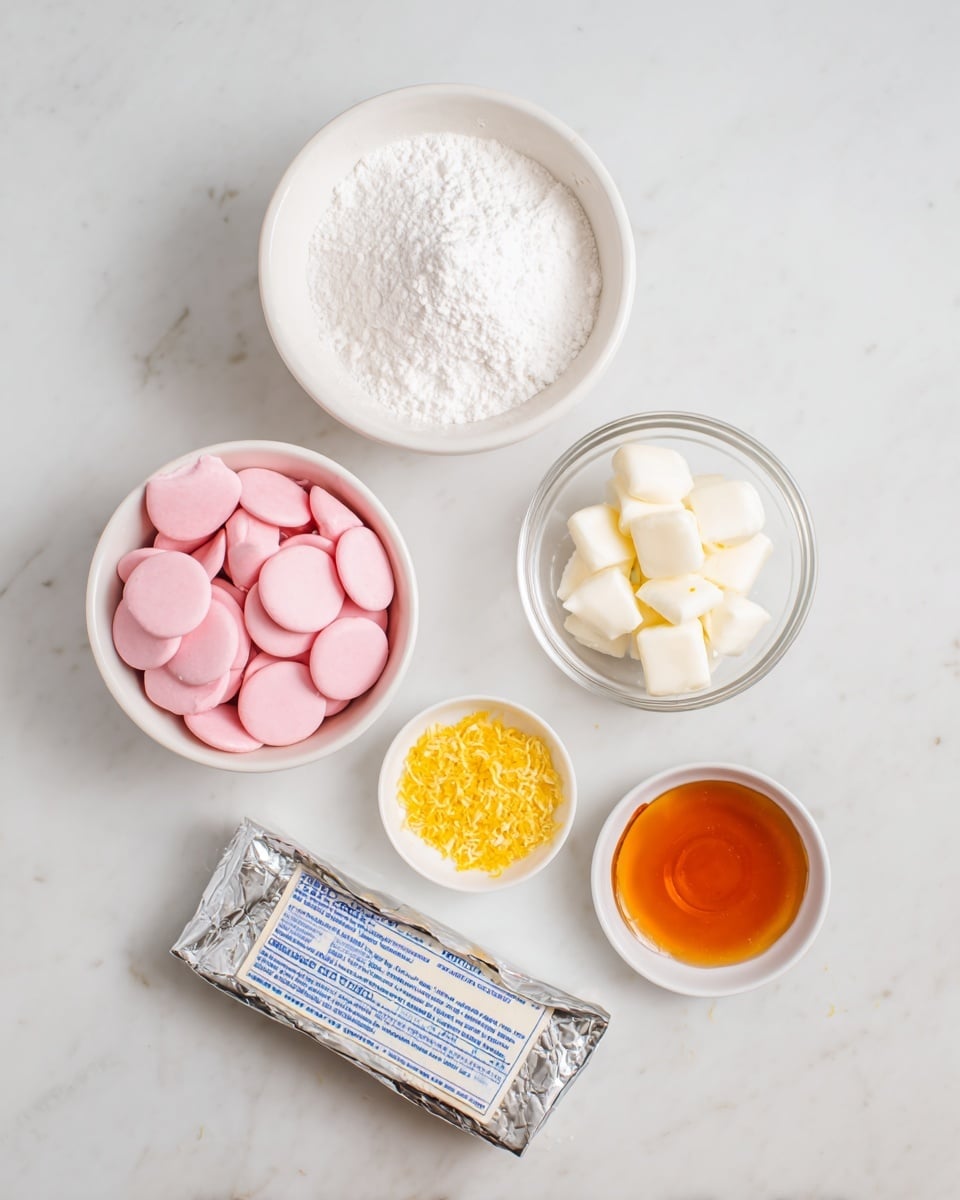 A top-down view of six small bowls and one wrapped block of cream cheese arranged neatly on a white marbled surface. The top left bowl is filled with a mound of fine white powdered sugar. Below it, a white bowl is filled with smooth, flat, round pink candy melts. To the right of the pink melts, a small clear glass bowl holds white candy melts that are similar in shape but smaller in size. Below this, a tiny white bowl is filled with finely grated yellow zest, likely lemon. The wrapped block of cream cheese, silver with blue text, is positioned in the bottom center. To the far right, a smaller white dish contains an amber liquid, possibly vanilla extract. The photo taken with an iphone --ar 4:5 --v 7