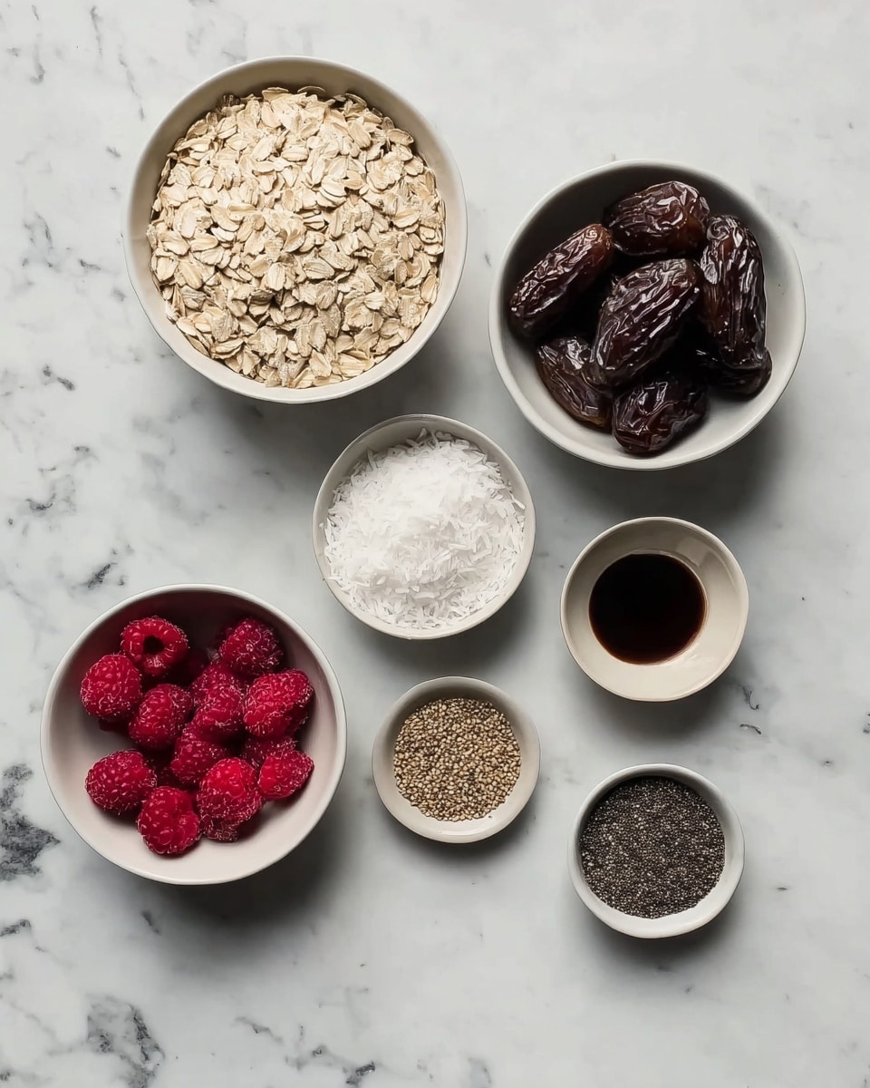 The image shows seven small white bowls arranged on a white marbled surface. The largest bowl in the top left has light beige rolled oats. To its right is a slightly larger bowl filled with dark brown dates that have a shiny texture. Below the oats is a bowl with fine, white shredded coconut, and next to it is another bowl with bright red frozen raspberries with a frosty texture. A very small bowl at the bottom holds fine white salt, while to the left of the coconut is a small bowl with light brown chia seeds. On the far right, near the middle, is a tiny bowl with dark black powder, and above it is another tiny bowl with thick dark brown liquid inside. The setting is simple and neat, with clear focus on the natural colors and textures of each ingredient, photo taken with an iphone --ar 4:5 --v 7