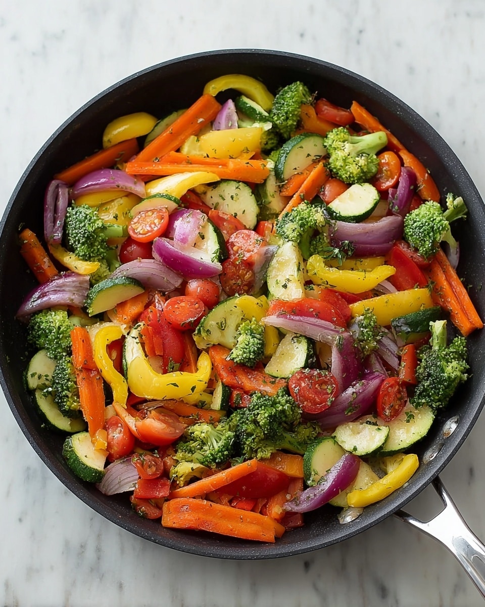 A black frying pan filled with a colorful mix of cooked vegetables on a white marbled surface. The vegetables include bright orange carrot sticks, green broccoli florets, yellow squash slices, red bell pepper strips, purple onion slices, green zucchini chunks, and red grape tomato halves. The vegetables are evenly spread throughout the pan, showing a mix of soft and firm textures with some herbs sprinkled on top. The frying pan has a silver handle visible on the right side. photo taken with an iphone --ar 4:5 --v 7