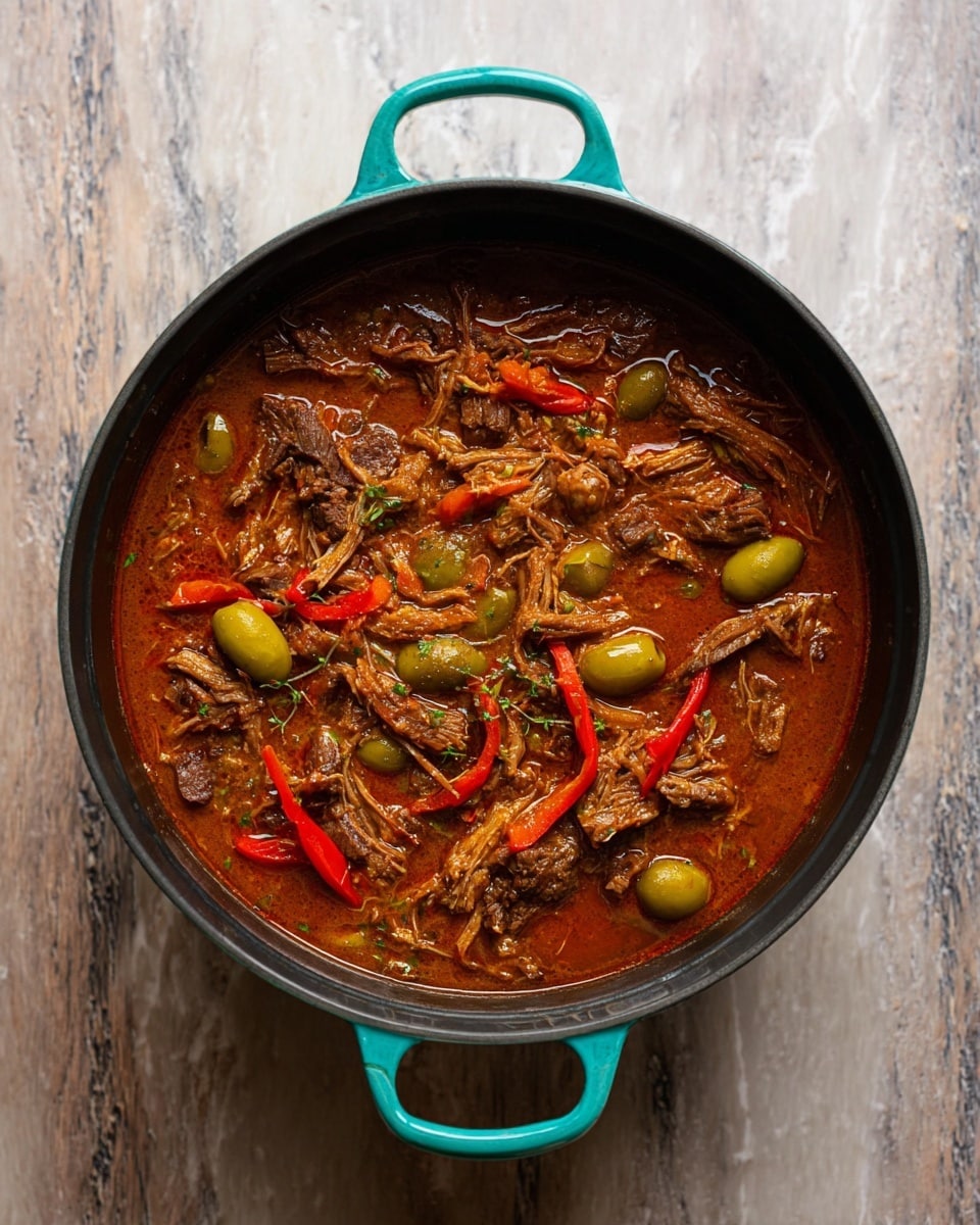 A round black pot with turquoise handles holds a rich stew. Inside, there are shredded pieces of brown meat mixed with green olives and red pepper strips, all swimming in a thick reddish-brown sauce. The stew has a hearty texture with visible chunks of meat and vegetables spread evenly throughout. The pot is placed on a white marbled textured surface. photo taken with an iphone --ar 4:5 --v 7