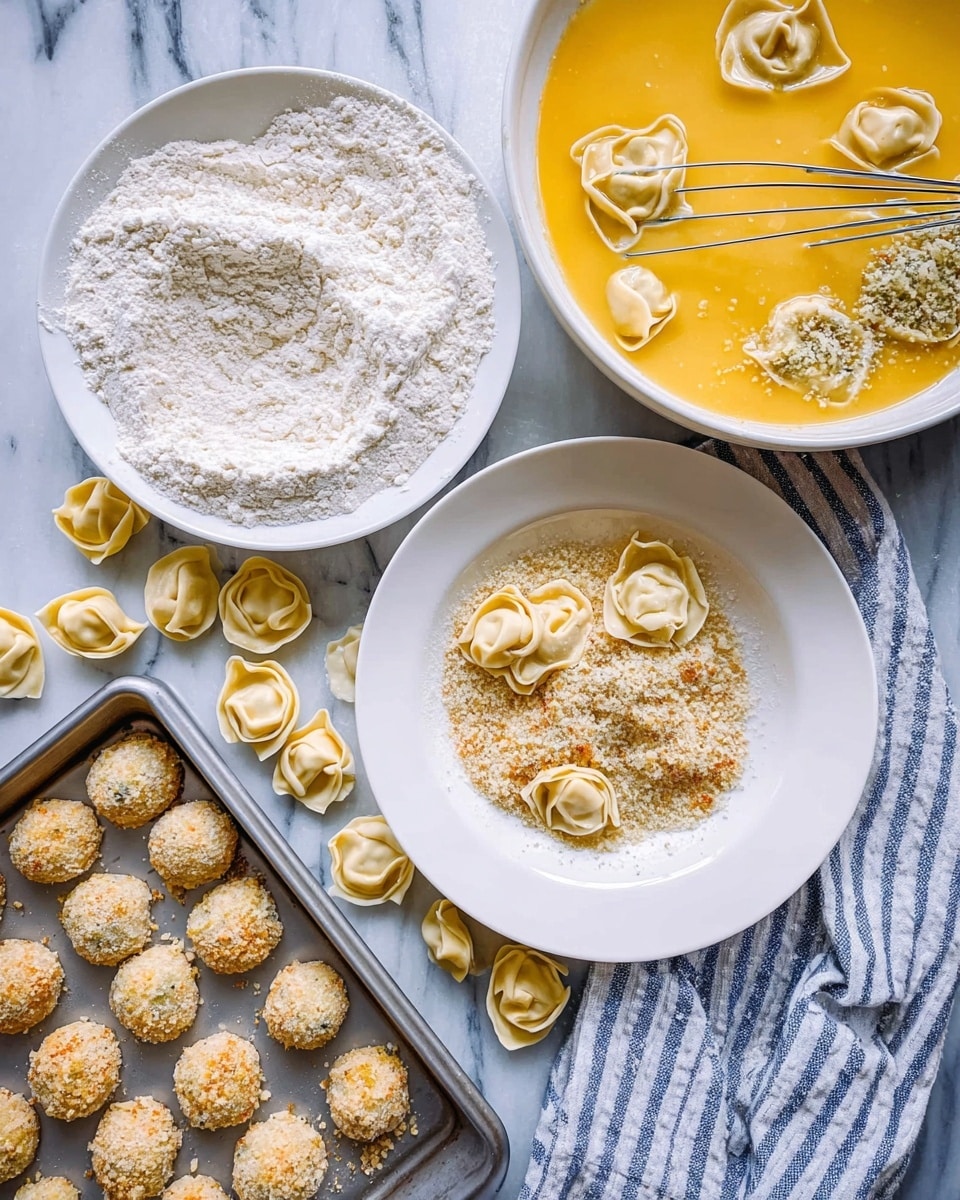 The image shows four main layers arranged for making a dish with tortellini. The first layer, at the top left, is a white plate with flour and uncooked tortellini partly covered in flour. The second layer, right next to it on the right, is a white plate filled with a yellow egg wash or batter with some tortellini soaking inside and a whisk placed over it. Below, on the bottom left, is a white plate with breadcrumbs and tortellini partly covered in the breadcrumbs. Scattered tortellini pieces are on the white marbled surface surrounding the plates. At the bottom left corner, there is a baking tray with evenly spaced breaded balls ready to bake. A white and blue striped cloth is placed on the bottom right. Photo taken with an iphone --ar 4:5 --v 7