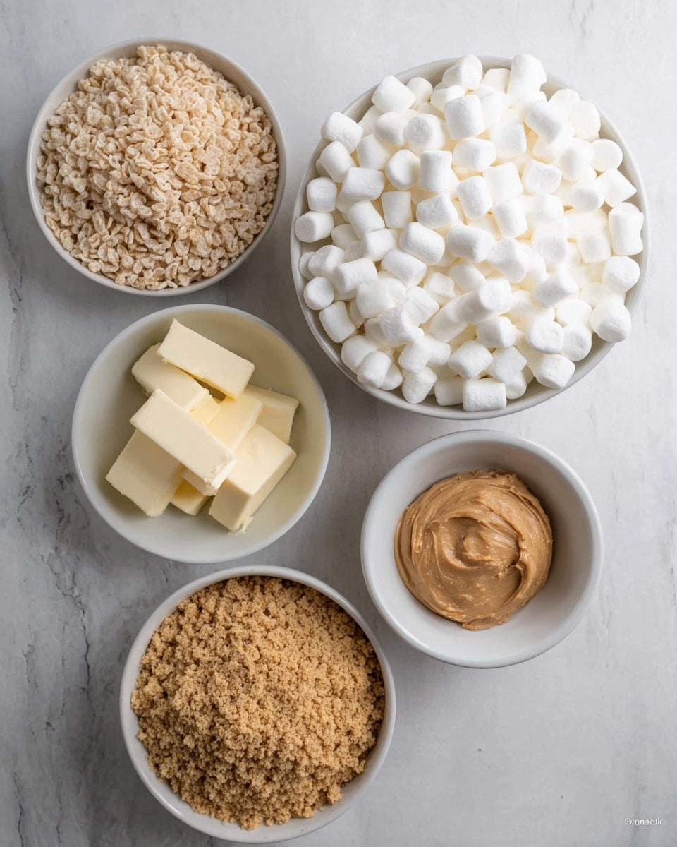 The image shows five bowls arranged on a white marbled surface. The largest bowl, at the top right, is filled with many small white marshmallows. To the left of it is another large bowl filled with light tan puffed rice cereal. Below these are three smaller white bowls. The one in the center holds four cubes of pale yellow butter. To the left, another bowl contains crushed golden brown graham crackers. To the right, the last bowl is filled with a dollop of smooth light brown peanut butter. photo taken with an iphone --ar 4:5 --v 7