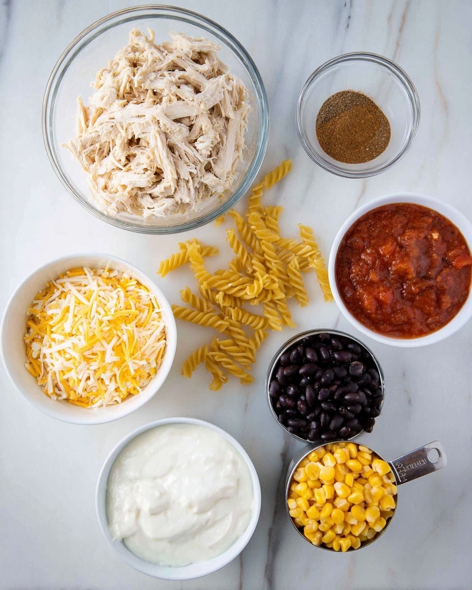 The image shows seven separate bowls and a measuring cup placed on a white marbled surface. At the top center is a clear bowl filled with shredded cooked chicken, light beige in color. Below that is a small glass bowl with a brown spice powder in the middle. To the right is a clear measuring cup with chunky red tomato sauce. Below it, there is a white bowl filled with dark black beans. To the left, a white bowl holds shredded yellow and white cheese mixed together. Below that is another white bowl with thick white sour cream. At the bottom center is a metal ⅓ cup measuring cup filled with yellow corn kernels. Scattered in the center are dry uncooked yellow spiral pasta pieces. Photo taken with an iphone --ar 4:5 --v 7