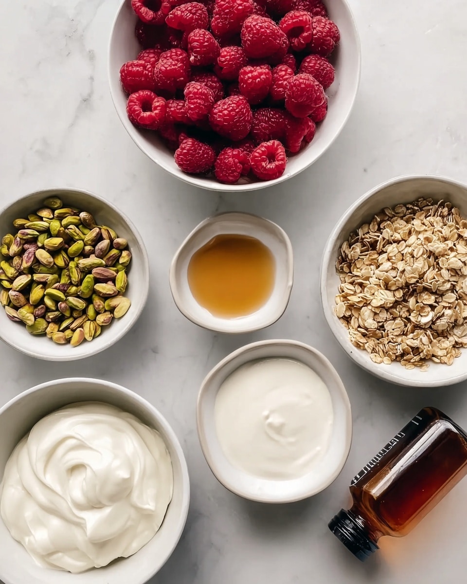 The image shows six white bowls arranged on a white marbled surface, each containing different ingredients. One bowl is filled with fresh red raspberries, showing their textured, bumpy surface. Another bowl holds yellow-green pistachios with some brown tones. A third bowl contains granola, light brown with green bits mixed in, showing a rough and crunchy texture. Another bowl has smooth, creamy white yogurt with soft swirls on top. Two smaller bowls are placed in the middle, one empty with a smooth white surface, and the other holding a small amount of golden-brown liquid. Near the bottom right, a clear brown bottle with a black cap lies on its side. Photo taken with an iphone --ar 4:5 --v 7