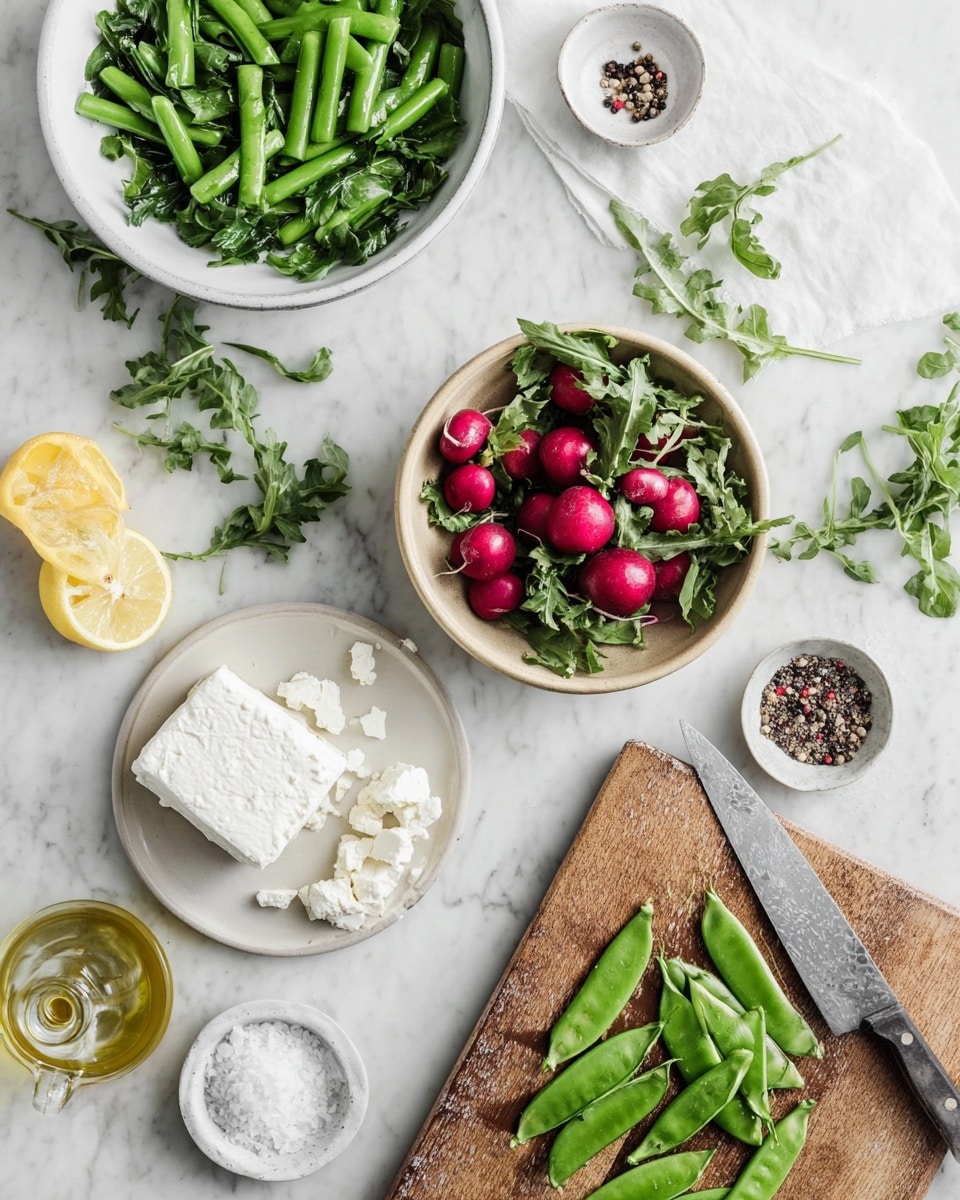 The image shows a white marbled surface with several fresh ingredients arranged on it. At the top left is a white bowl filled with bright green snap peas, next to it is a white bowl packed with dark green leafy arugula. In the middle sits a beige bowl full of small, round, red radishes with some green leaves attached. To the right is a white plate holding a block of crumbly white cheese, with some pieces broken off. At the bottom left, there is a halved squeezed lemon, a small white bowl of coarse salt, and a small bowl of mixed black and red peppercorns. Near the center bottom, a glass bottle of olive oil is visible. A wooden cutting board sits on the bottom right side with green snap peas, some whole and some sliced open showing the peas inside. A silver knife with pea residue rests next to the board. photo taken with an iphone --ar 4:5 --v 7