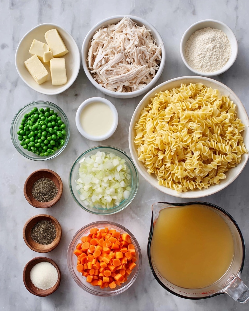 Several small bowls and measuring cups are arranged on a white marbled surface, each holding different ingredients. In the center, there is a white bowl filled with yellow dry egg noodles that are curly and textured. To the left of the noodles is a white bowl containing shredded pale chicken meat, and below it, a small white bowl with green peas. In clear glass bowls, there are finely chopped white onions and diced orange carrots positioned side by side near the bottom center. Around these main bowls, there are several small wooden bowls holding black pepper, two small pieces of off-white butter, salt, and minced garlic. To the right of the noodles, there are two measuring cups, one with a beige flour powder and the other with cream colored milk. In the lower right corner is a large measuring cup filled with golden broth. All items are neatly placed and clearly visible. Photo taken with an iphone --ar 4:5 --v 7