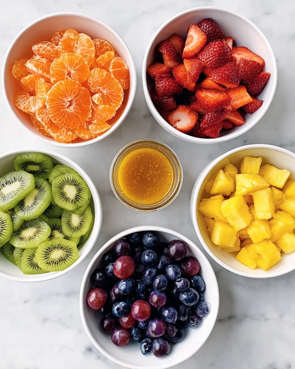 Six white bowls arranged in a circle on a white marbled surface with a small glass jar of orange dressing in the middle. The bowls each hold different fruits: top left has bright orange peeled mandarin slices, top right is filled with deep red sliced strawberries, middle left contains green sliced kiwi with visible seeds, middle right has a mix of dark purple and red grapes, bottom left is full of dark blue blueberries, and bottom right holds bright yellow pineapple chunks. The fruit pieces show fresh textures and vibrant colors. photo taken with an iphone --ar 4:5 --v 7