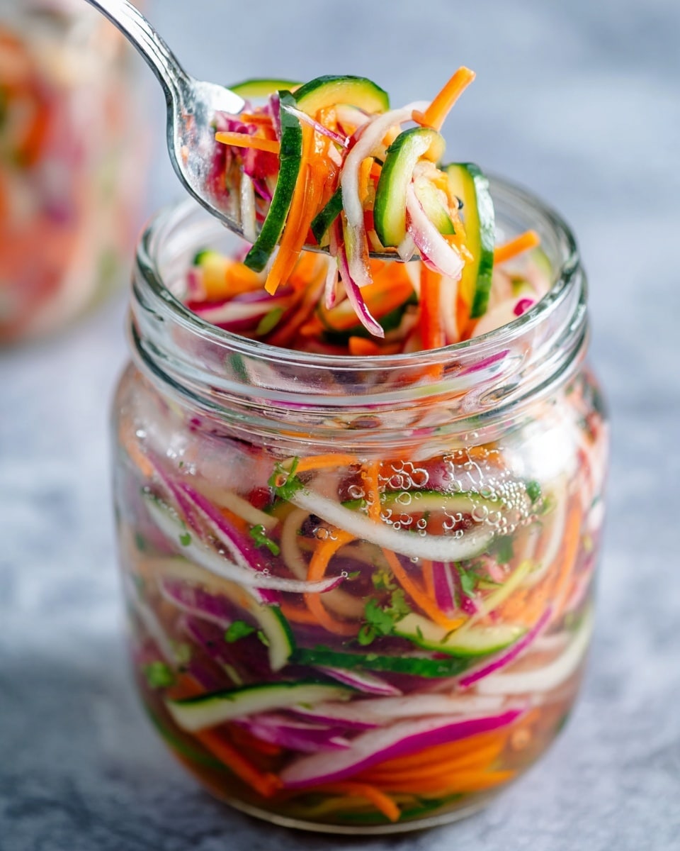 A clear glass jar filled with multiple layers of thin vegetable strips, including bright orange carrot, dark purple onion, green cucumber, and white radish with red edges, all mixed in liquid with small bubbles visible on the jar surface. At the top, a silver fork lifts a colorful mix of the same vegetables, showing their fresh and crisp texture against a white marbled surface blurred in the background. The visual layers in the jar show a vibrant mix of colors blending together in liquid. Photo taken with an iphone --ar 4:5 --v 7