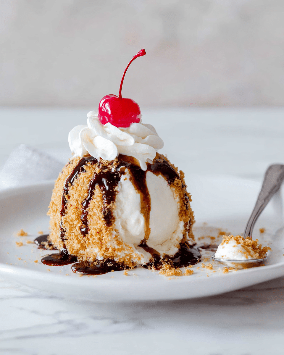A round scoop of white ice cream sits on a white plate with a white marbled surface, covered in a crunchy golden crumb layer. The ice cream ball is topped with a swirl of fluffy white cream and a bright red cherry with a long stem. Dark brown chocolate sauce is drizzled over the ice cream and crumb coating, dripping slightly onto the plate. To the right, a silver spoon holds a portion of the ice cream with crumbs. Photo taken with an iphone --ar 4:5 --v 7