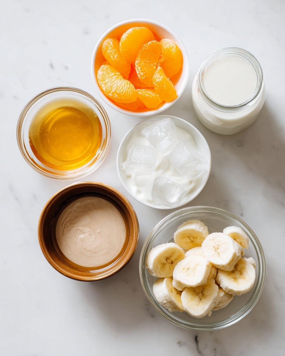 The image shows six small bowls and a glass jar arranged on a white marbled surface. Starting from the bottom left, there is a small clear bowl filled with golden honey. Above it, a white bowl holds bright orange fruit slices. Next to it on the right is a white bowl filled with clear ice cubes. Above the ice, a white bowl contains thick white yogurt. In the center is a small brown bowl with a smooth, round interior holding a light brown liquid with some texture. At the bottom right, a clear glass bowl contains round, thick slices of banana, showing pale yellow flesh with a darker center. To the top right of the image is a clear glass jar filled with white milk. The arrangement is neat with each item clearly visible, and the lighting makes the colors fresh and soft. Photo taken with an iphone --ar 4:5 --v 7