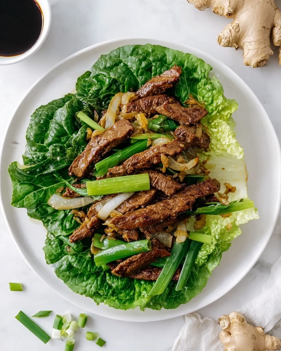 A white plate is set on a white marbled surface, holding a bed of large, dark green leafy lettuce. On top of the lettuce are several brown, cooked strips of meat, mixed with pale golden cooked onion slices and bright green, chunky pieces of green onion. Around the plate, there are some small pieces of fresh green onion scattered on the white marbled surface, along with a piece of fresh ginger root and a small white bowl partly visible, filled with dark soy sauce. Photo taken with an iphone --ar 4:5 --v 7