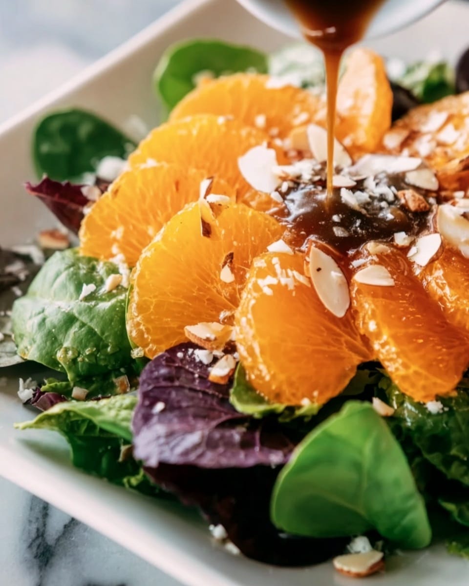 This image shows a close-up of a salad with three main layers. The bottom layer is fresh green spinach leaves mixed with some dark purple lettuce, all placed on a white plate. The middle layer has bright, thin, round orange slices carefully spread over the greens, showing their juicy texture. On the top layer, thin white almond slices and bits of crumbly white cheese are scattered evenly. A shiny dark brown dressing is being poured over the salad from above, creating a glossy effect on the orange slices. The whole setup is on a white marbled surface. photo taken with an iphone --ar 4:5 --v 7