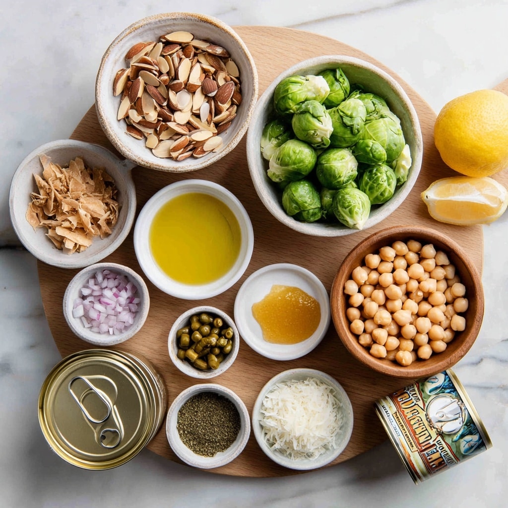 A white round plate with a wooden circular board covering most of its surface, holding a variety of small bowls and ingredients arranged neatly. On the top right side, a wooden bowl is filled with light tan chickpeas, with fresh middle-green Brussels sprouts piled next to it on the wooden board. At the top left side, a white bowl with a rough, textured rim is filled with toasted almond slices in dark and light brown tones. Below it, there is a small white bowl containing golden honey and a mustard-colored dollop, next to it a small white bowl filled with yellow olive oil. Near the bottom left of the wooden board, a small dark gray bowl contains finely chopped shallots in light purple and white colors. Next to it, a white bowl holds small dark green capers. A small green bowl holds green dried spices with some white flour-like powder on top. A small white bowl holds white shredded Parmesan cheese. An open tin of light tan tuna is on the lower left of the board, with a metallic pull tab. A whole bright yellow lemon and a tilted can with a colorful label partially showing artichoke hearts are placed at the bottom right edge of the plate. The surface beneath the plate is white marble with subtle gray veins, photo taken with an iphone --ar 4:5 --v 7