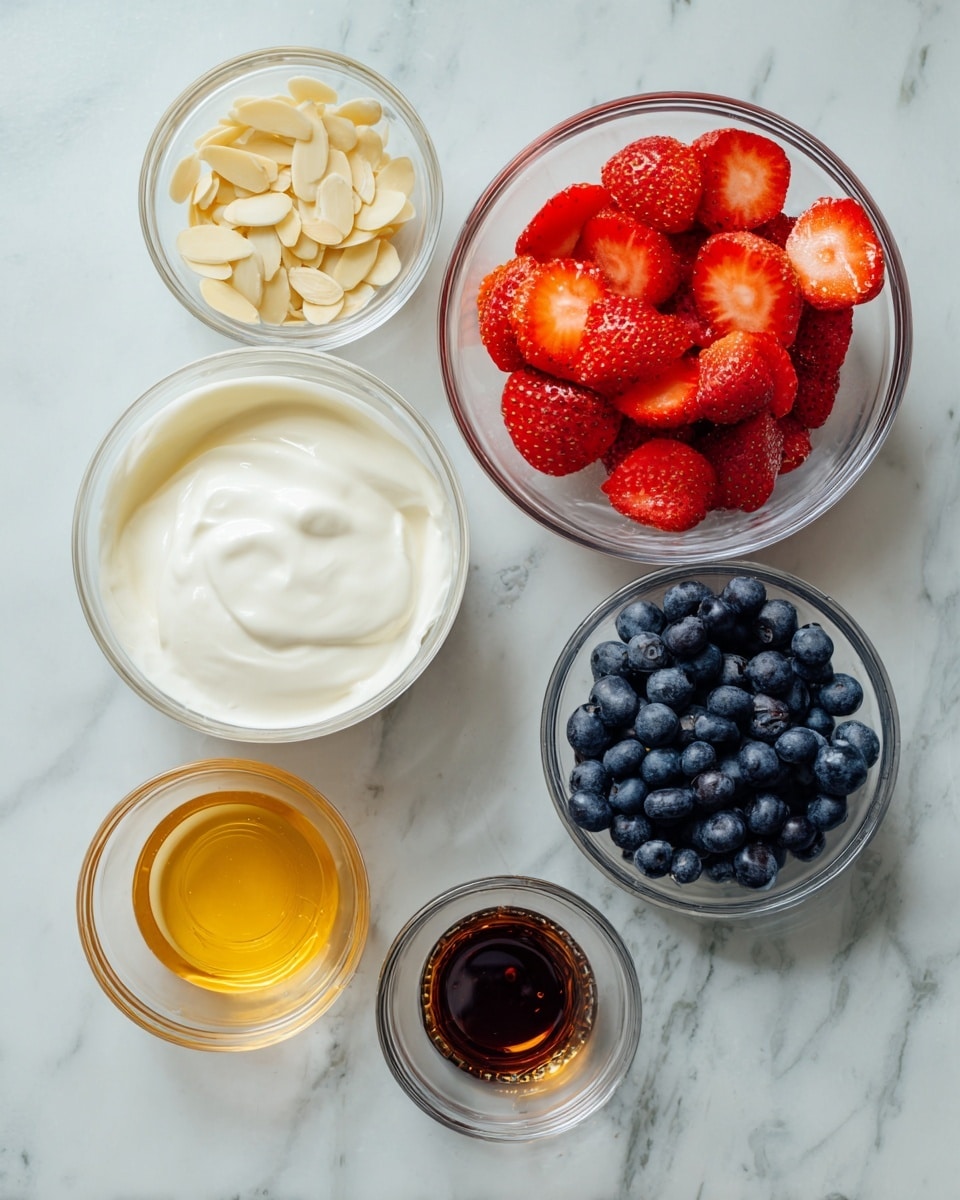 The image shows clear glass bowls filled with different fresh ingredients arranged on a white marbled surface. There is one large bowl of smooth, creamy white yogurt in the bottom left. To its right, a bowl of bright red, sliced strawberries fills the frame with juicy texture. Above the strawberries, a bowl of small deep blue blueberries rests, their surface slightly shiny. To the left of the blueberries, a smaller bowl of thin, pale yellow almond slices is shown. Below the almonds, a medium bowl holds golden-honey colored liquid with a shiny surface. Above the honey, a tiny bowl contains dark brown vanilla extract. To the far left, there is a plastic bottle of honey substitute with a yellow-orange tint. The ingredients are spaced out evenly on the white marbled surface. Photo taken with an iphone --ar 4:5 --v 7