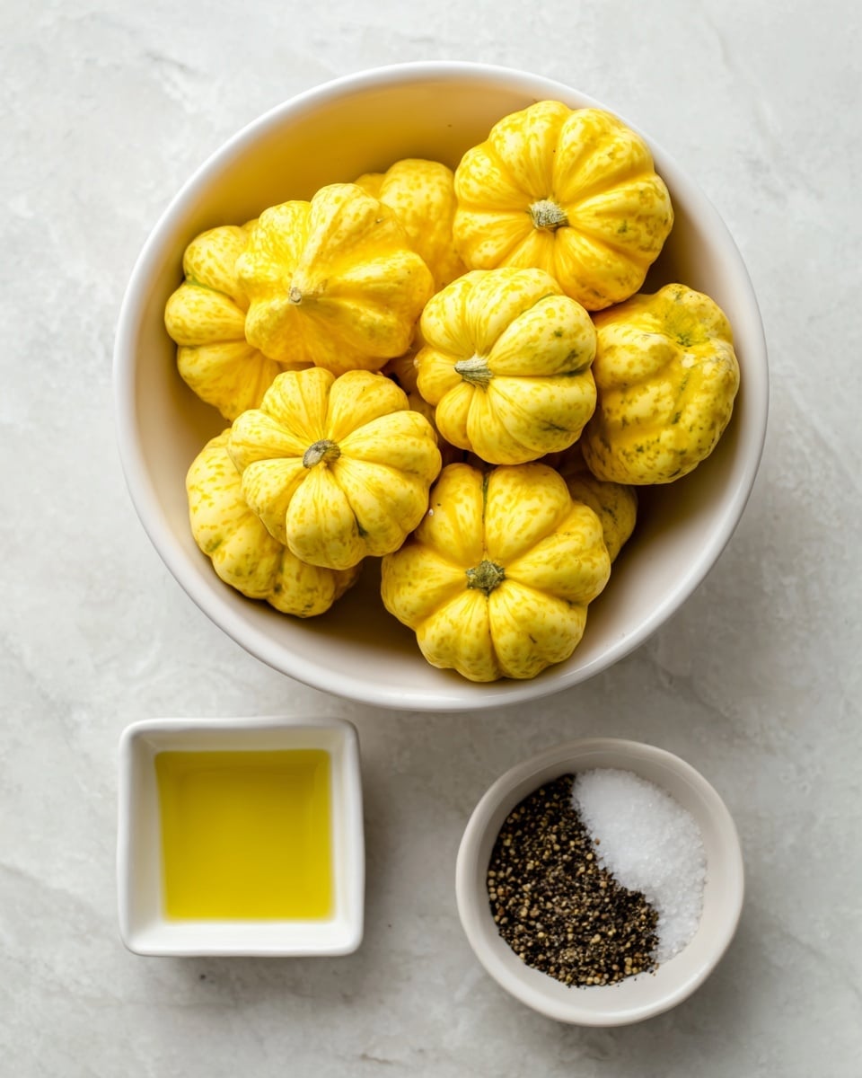 A white bowl full of bright yellow patty pan squash with a scalloped shape sits on a white marbled surface. To the right, there is a small white bowl with a mix of dark black pepper and white sea salt. Below that, there is a small white square dish filled with golden olive oil. Everything is brightly lit showing clear colors and textures. Photo taken with an iphone --ar 4:5 --v 7