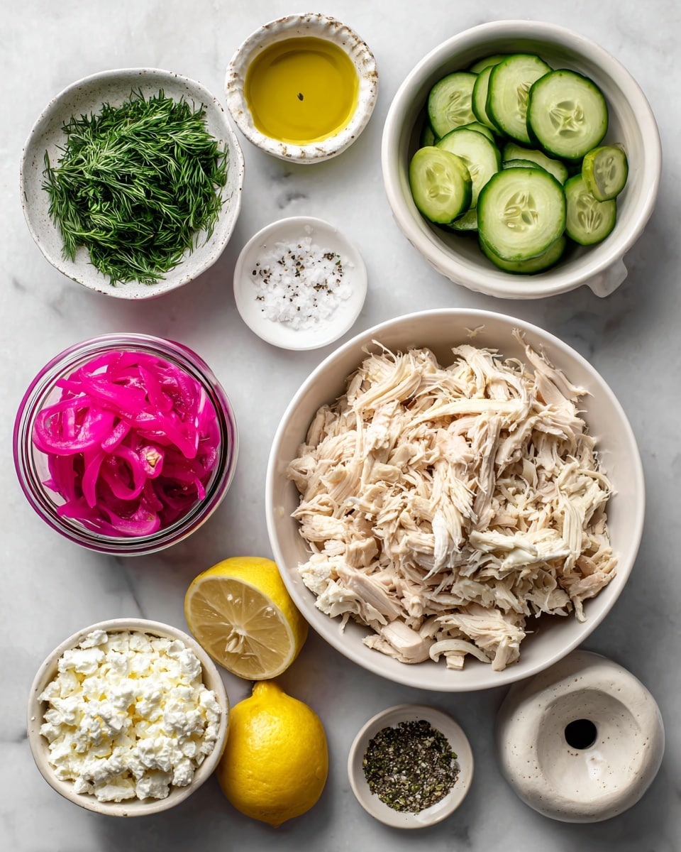 The image shows a top view of several white bowls and small jars arranged on a white marbled surface. In the center, a bowl is full of shredded pale beige chicken pieces with a fibrous texture. Above it and slightly to the right, another white bowl contains thin, round, green cucumber slices with visible seeds. To the left of the cucumbers, there is a small glass jar filled with bright pink pickled red onions that have a thin, stringy look. Above the chicken to the left is a small white bowl with finely chopped fresh dill, deep green in color. Next to the dill on the top left is a small white bowl of white salt mixed with black pepper. At the top center, a small jar holds a clear, golden yellow olive oil. Below the chicken bowl to the bottom right, there is a white bowl with crumbled, creamy white feta cheese. At the bottom left, a halved lemon shows its bright yellow interior next to a beige lemon juicer with subtle speckles on its surface. Photo taken with an iphone --ar 4:5 --v 7